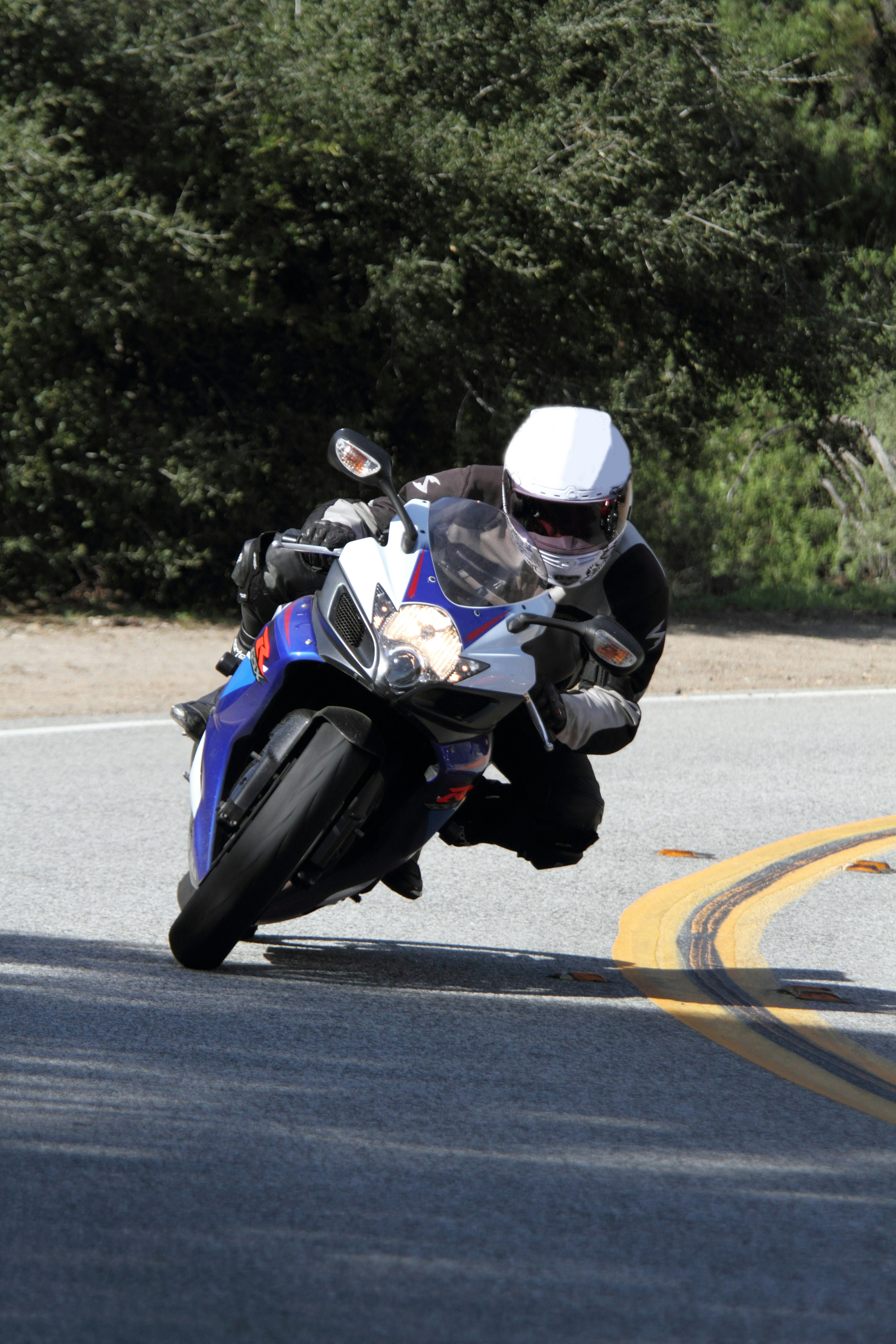 A rider leaning into a curve on a motorcycle