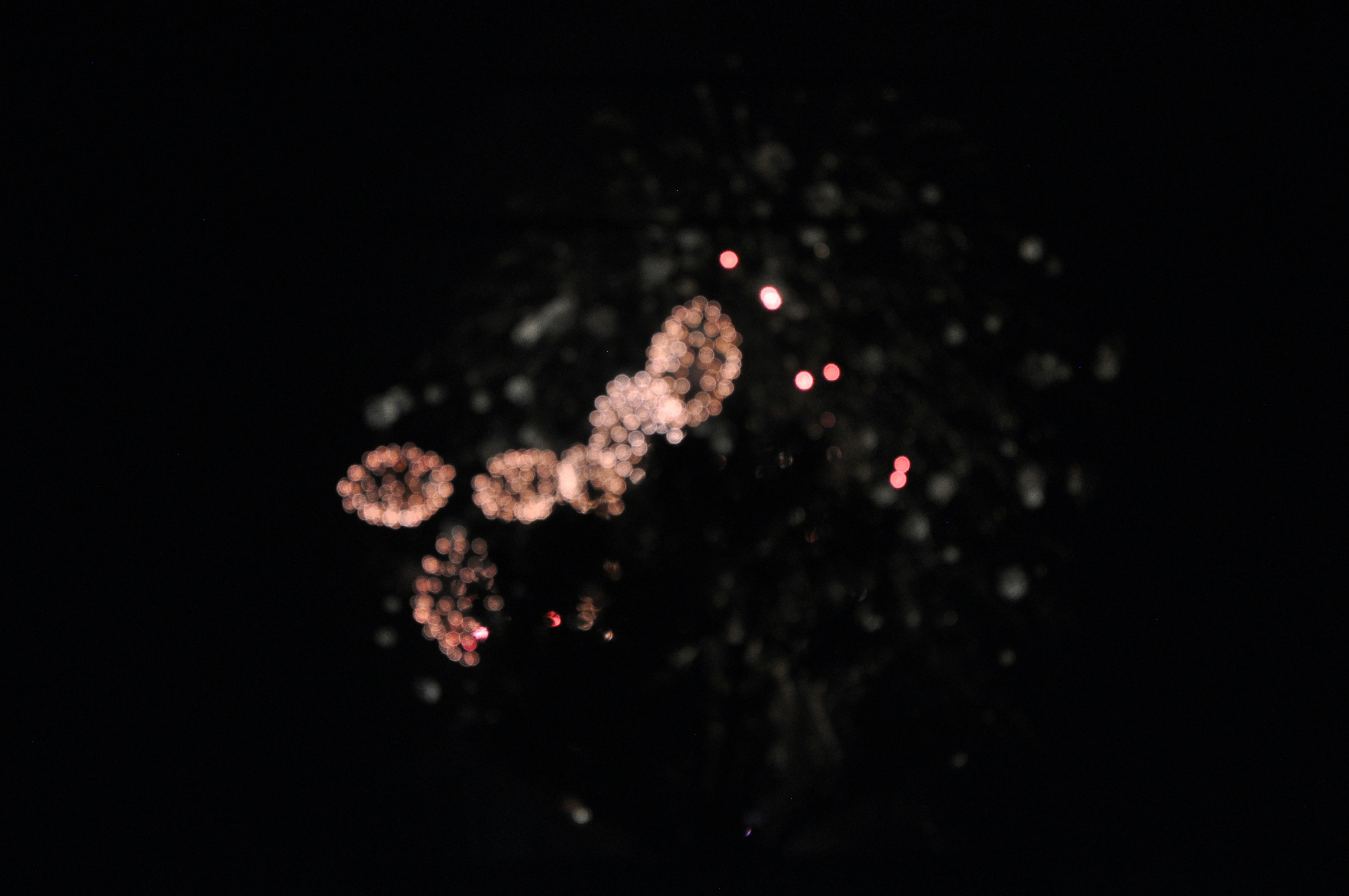 Fireworks bursting against a black background