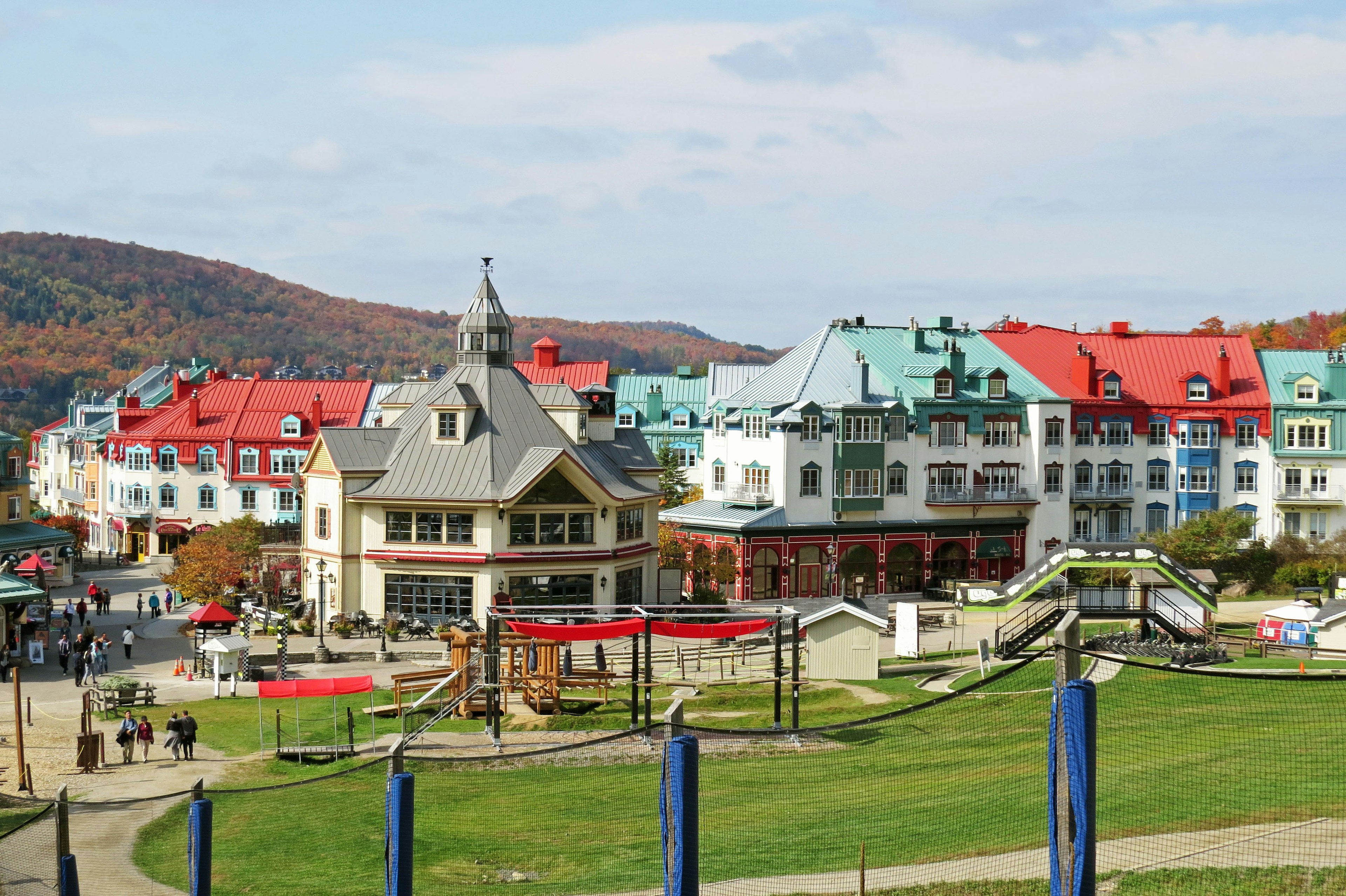 Colorful buildings with varied rooftops and an open square