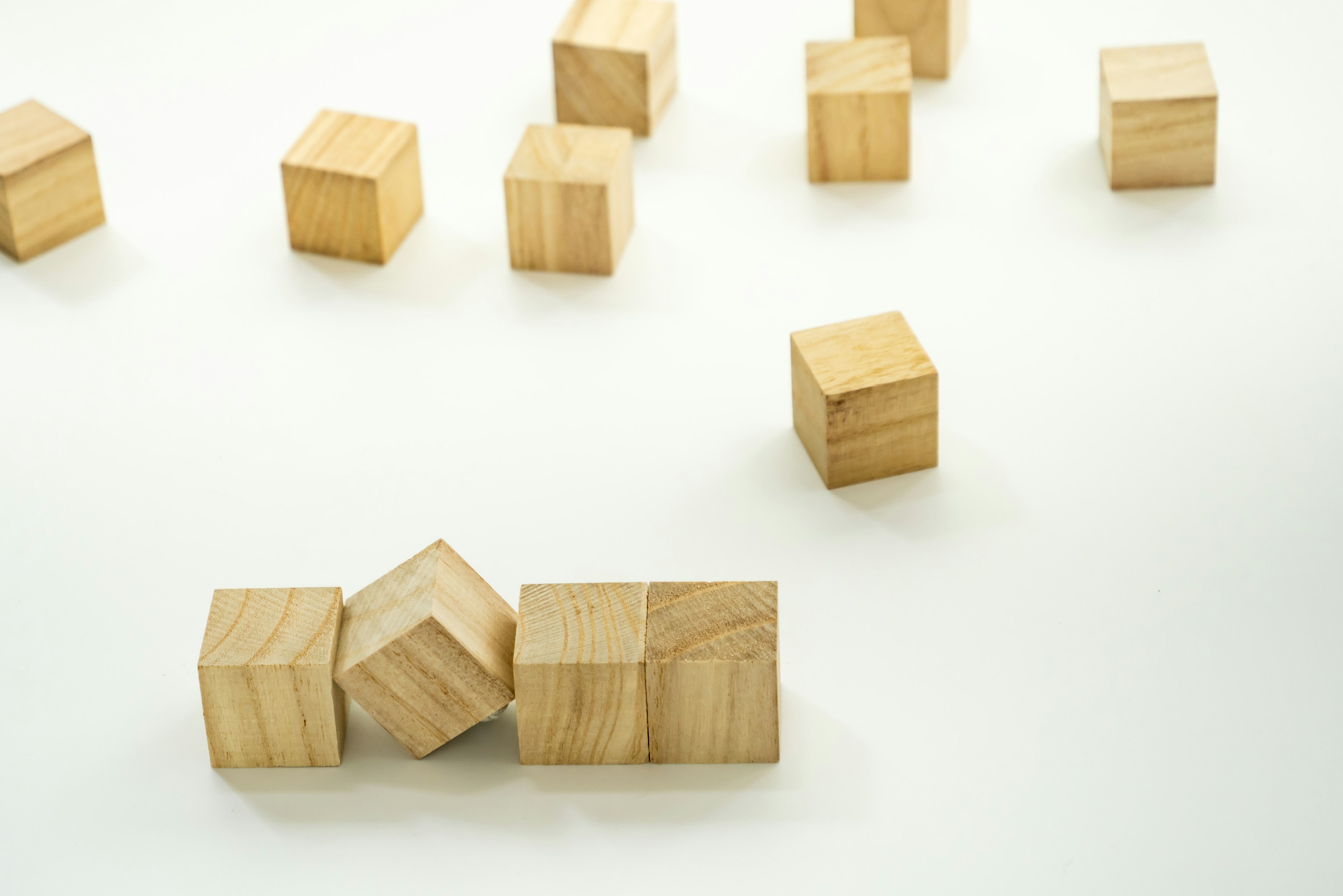 Wooden cubes scattered on a white background