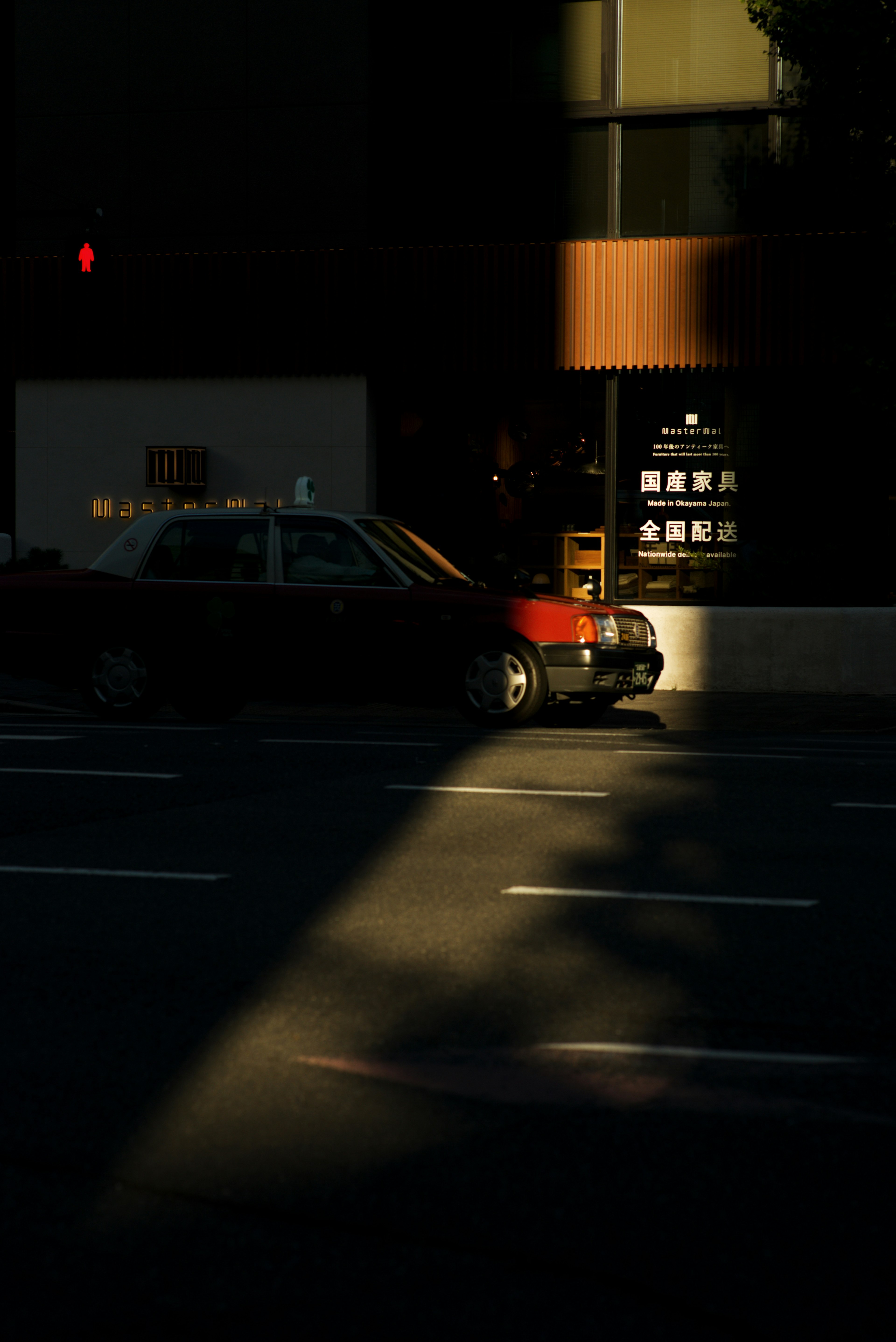 Taxi parked on a dimly lit street with urban scenery