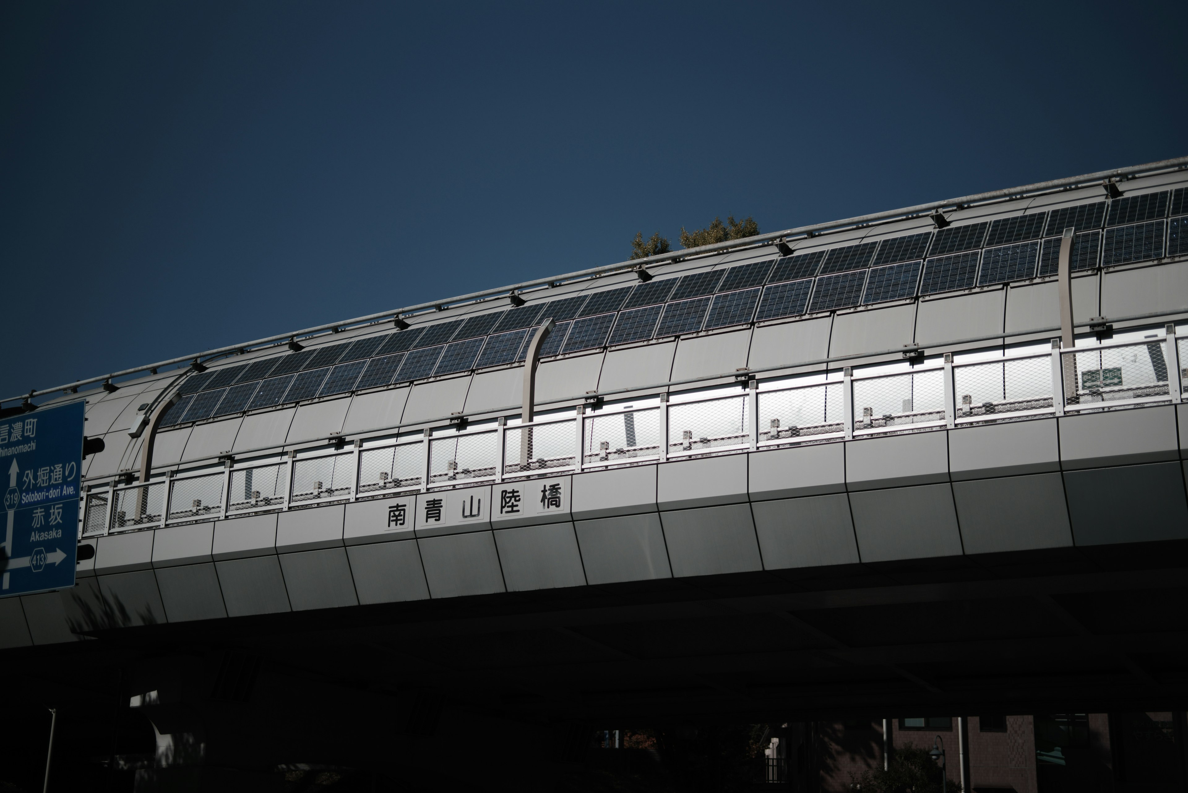 Modern elevated train station structure with glass windows