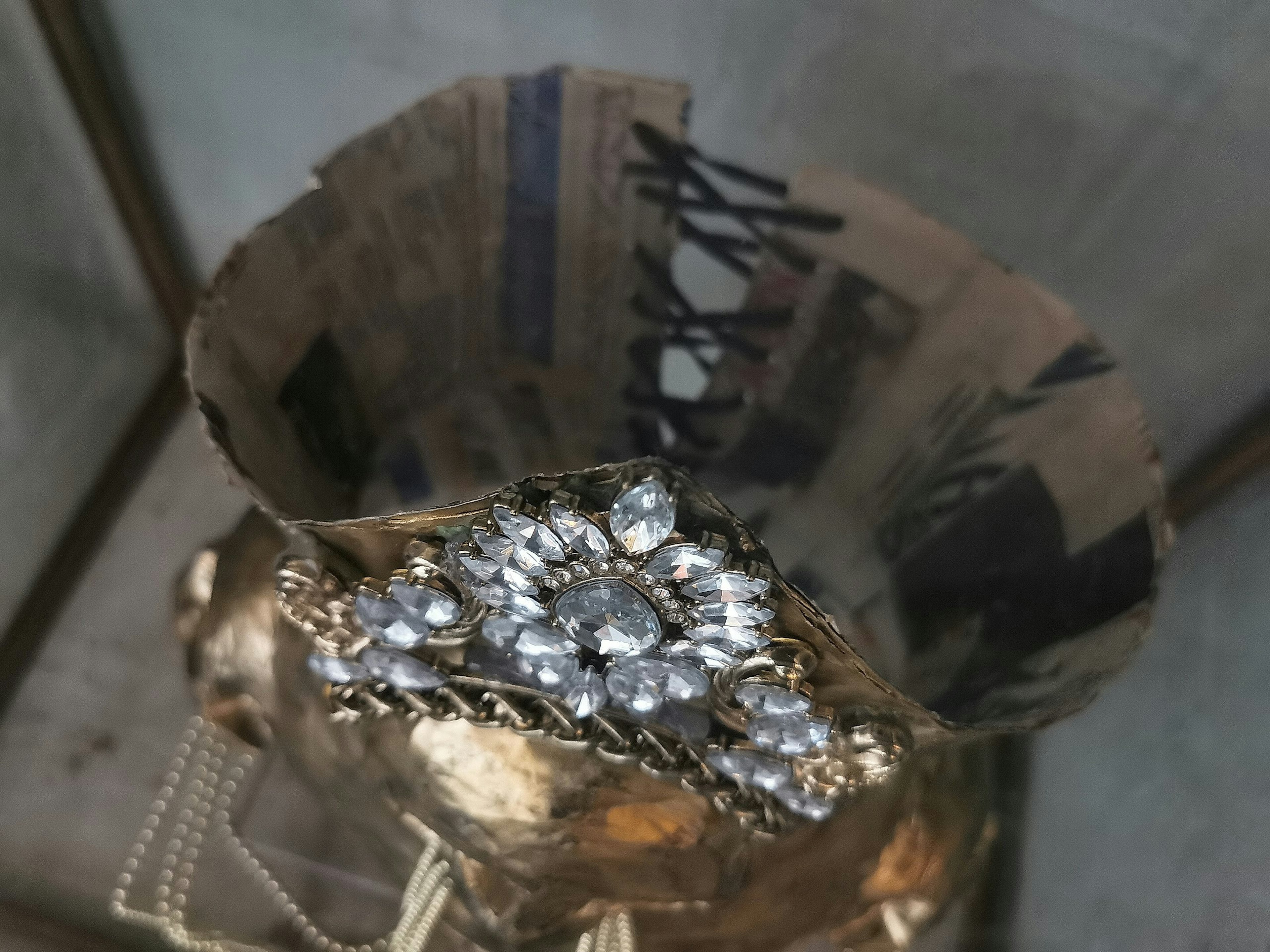 Close-up of a luxurious brooch atop a golden object