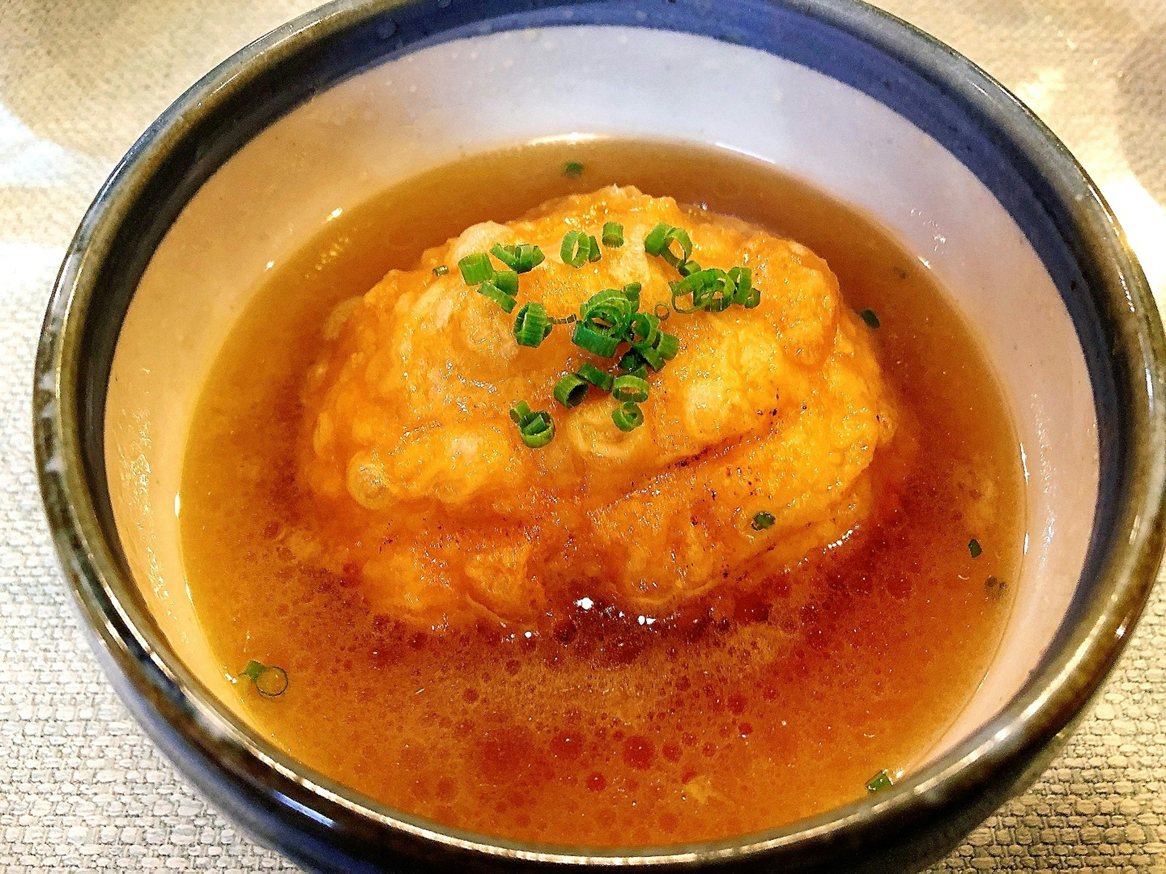 A serving of egg dish floating in warm broth