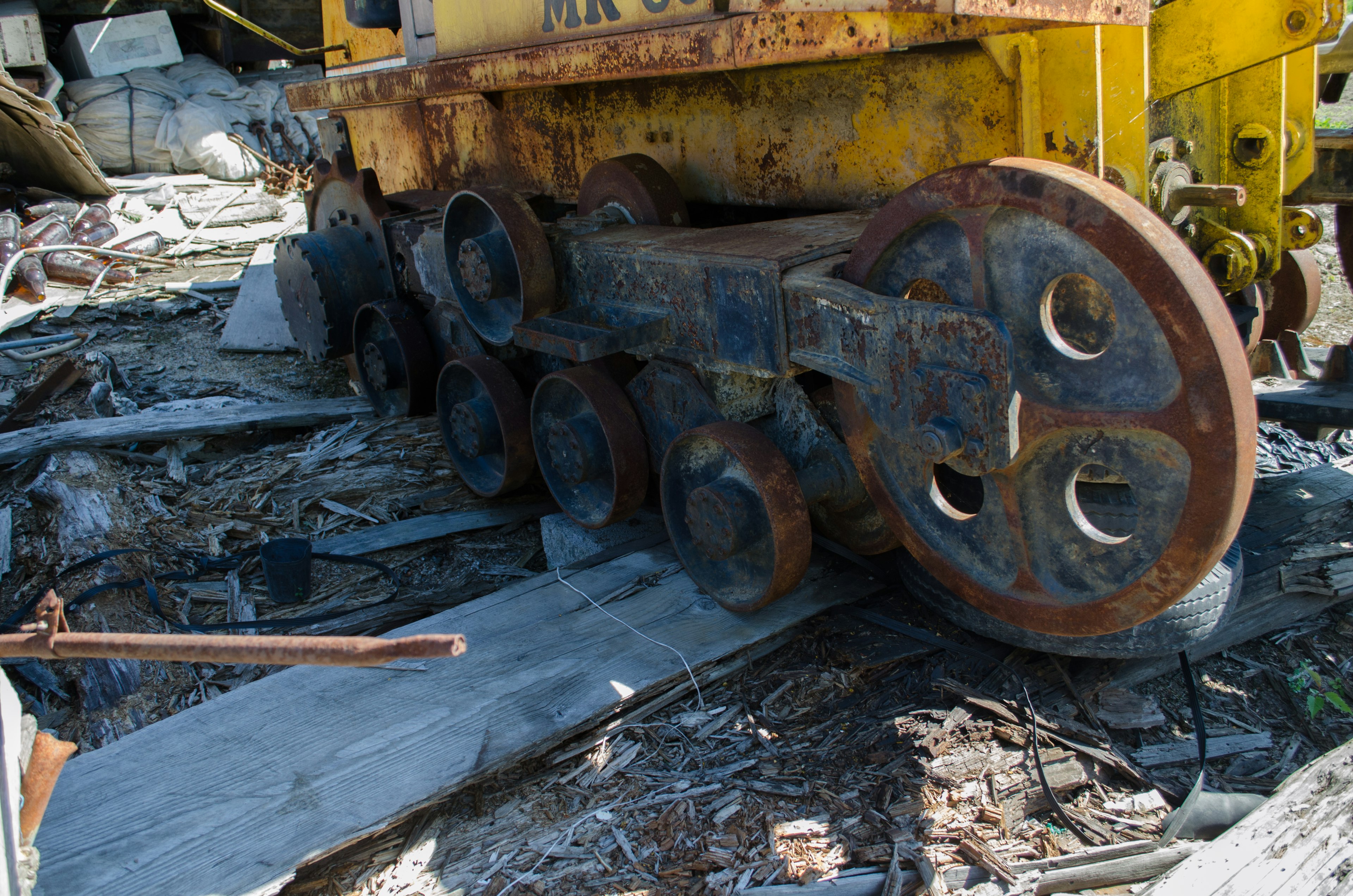 Worn wheels of an old machine in a decaying landscape