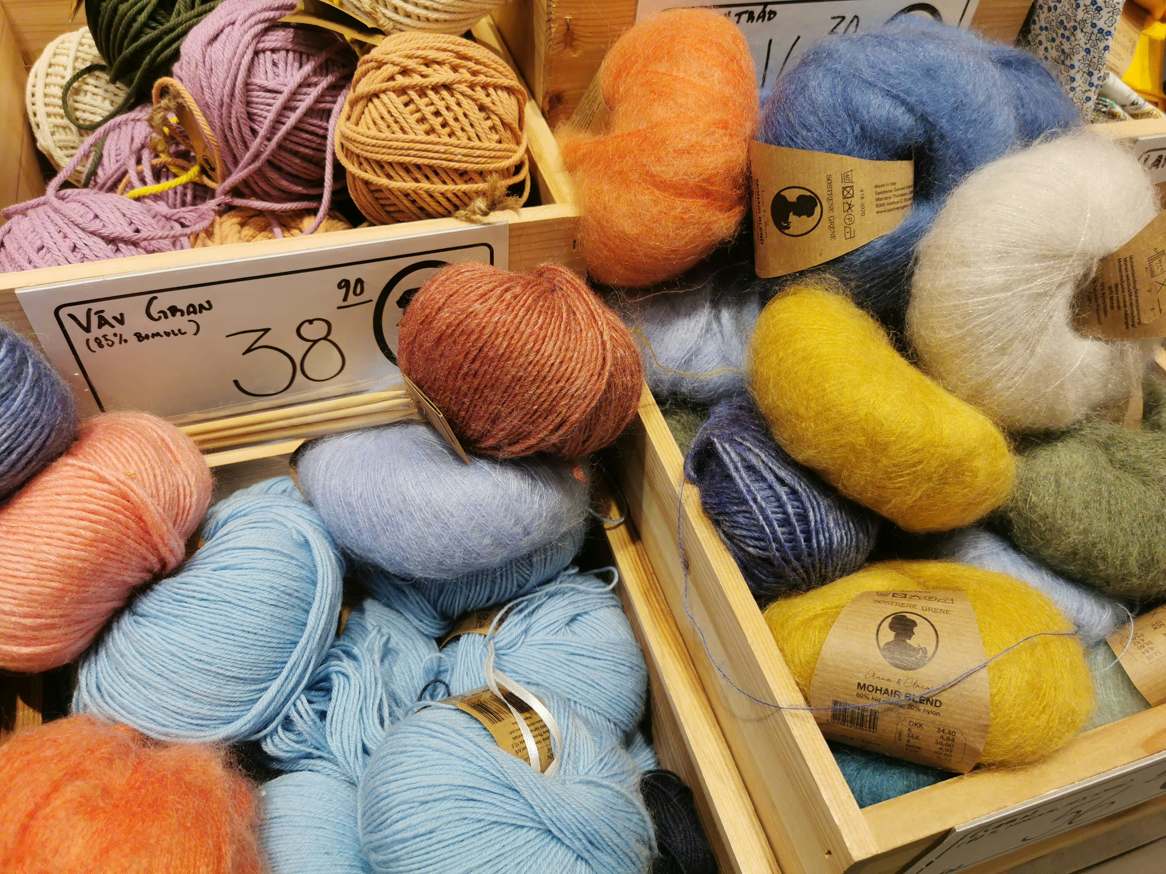 Image of colorful yarns in wooden boxes