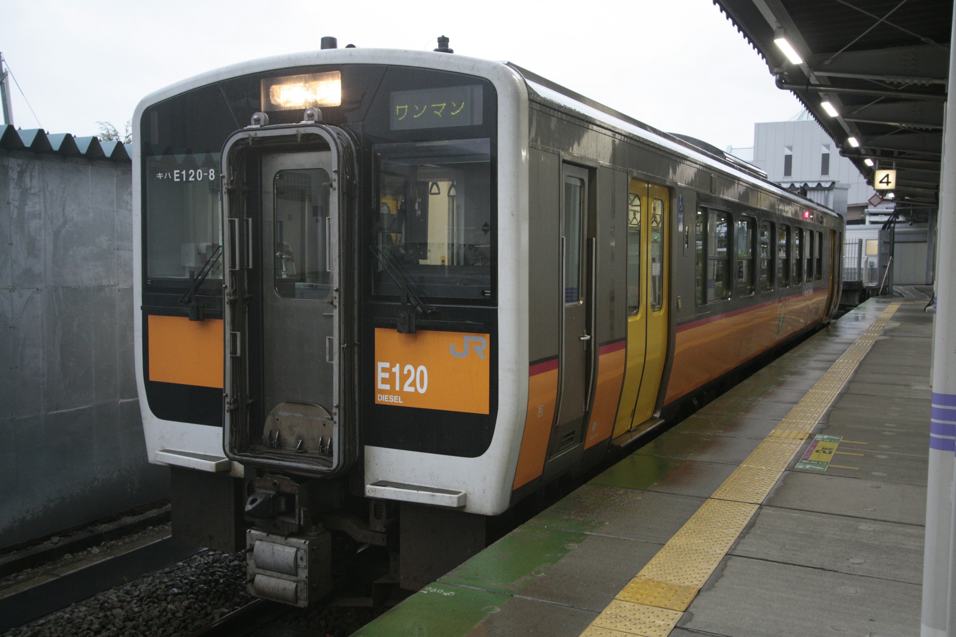 オレンジと白の電車が駅に停車中