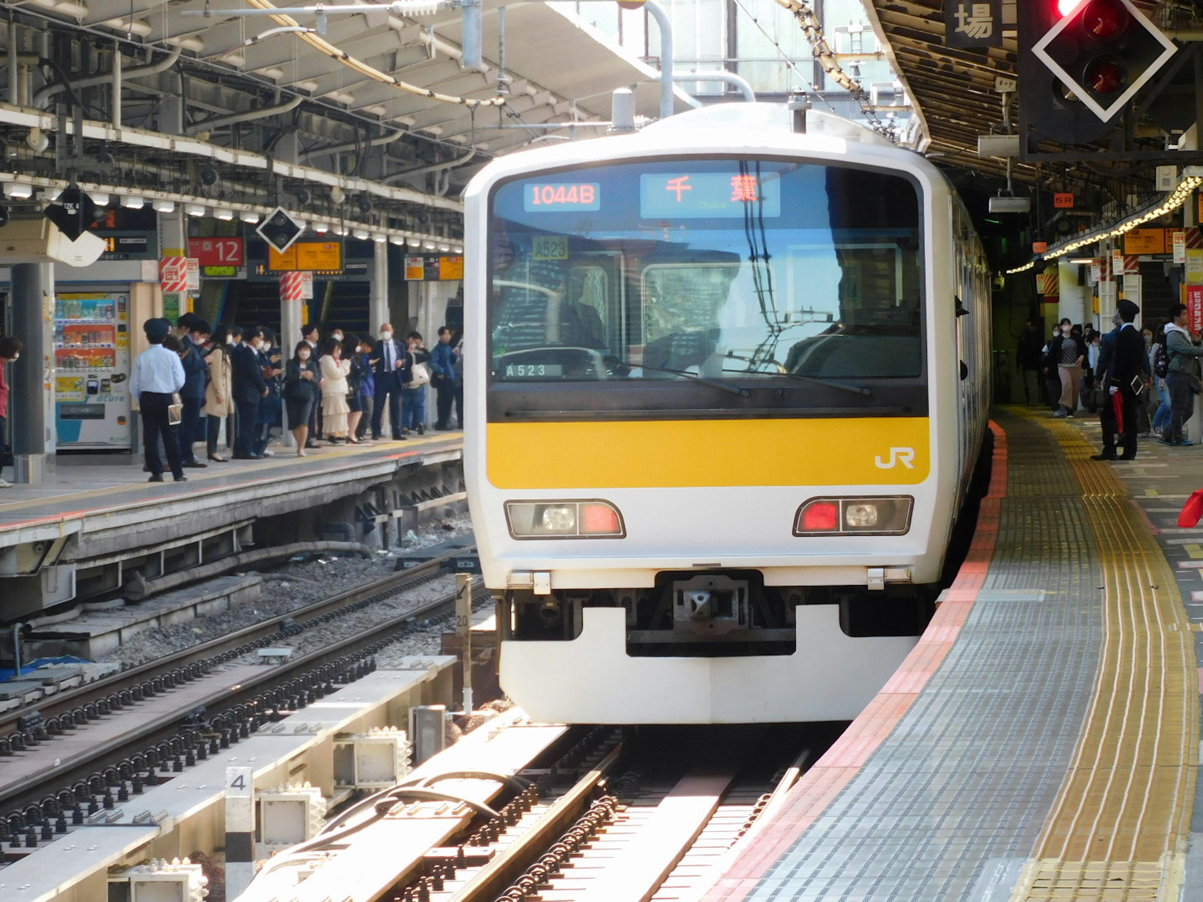 Kereta di stasiun dengan penumpang menunggu