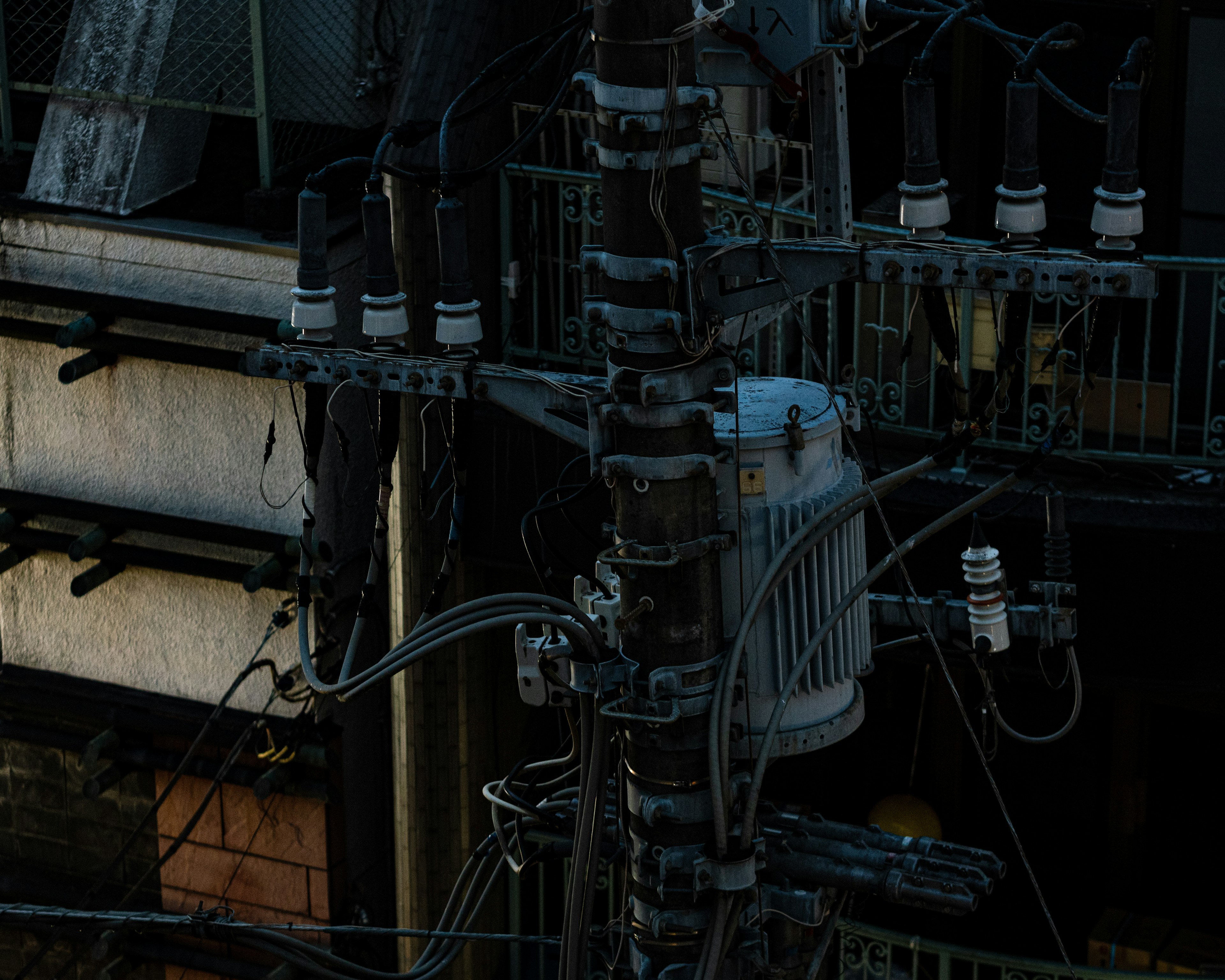 Close-up image of a utility pole and electrical distribution equipment