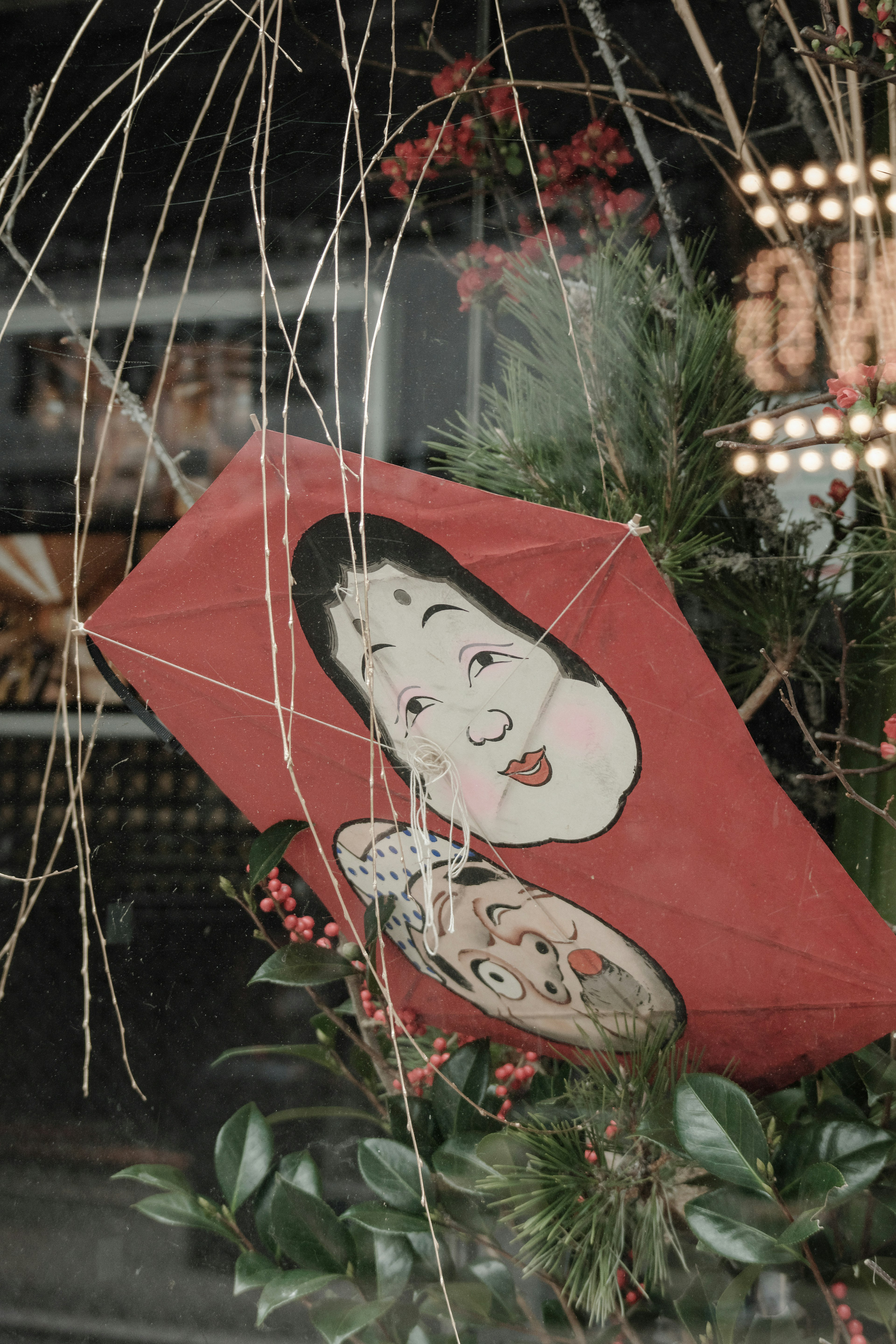 Traditional decoration featuring a red kite with painted faces