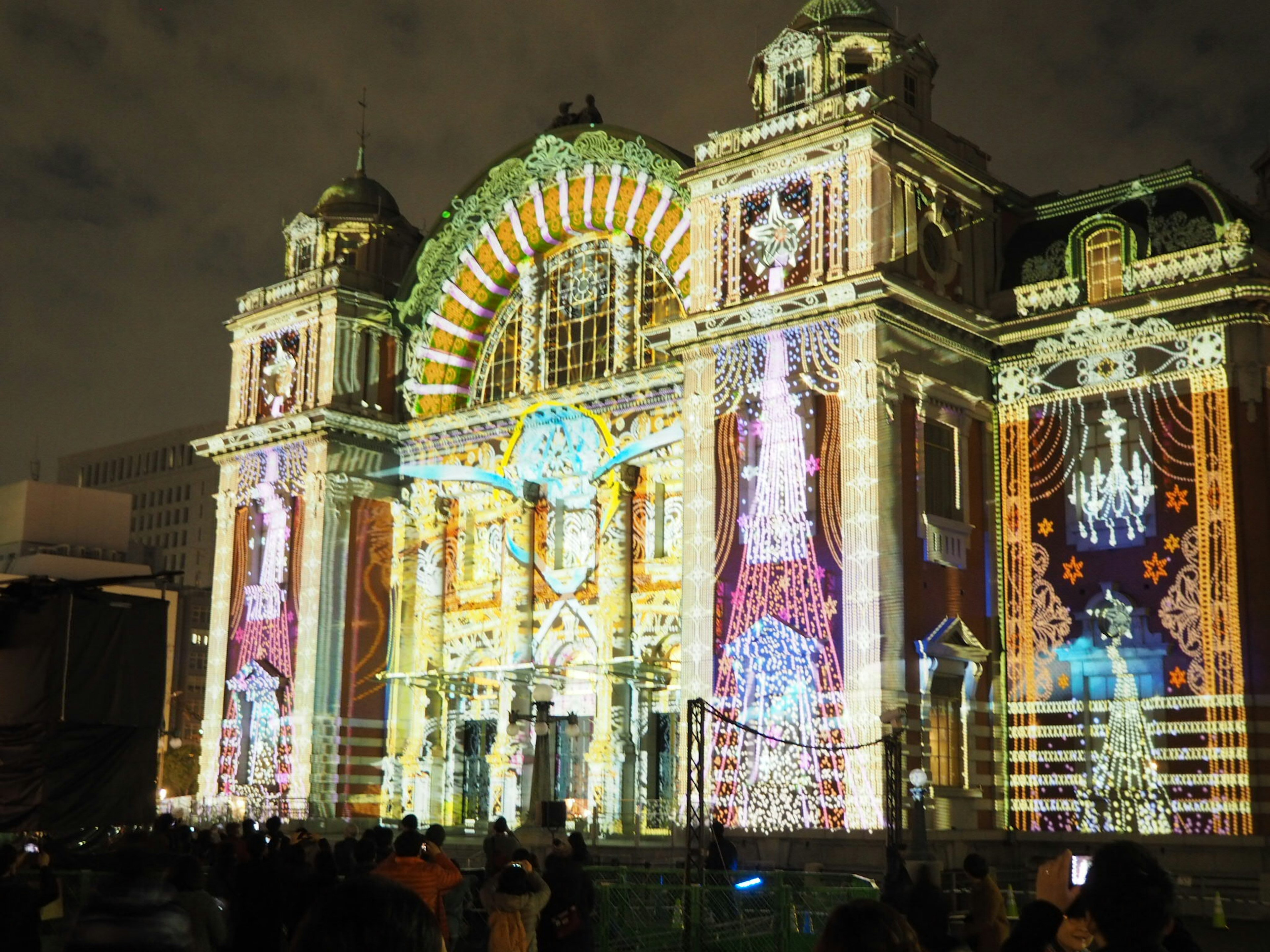 Historic building illuminated with a vibrant light show at night