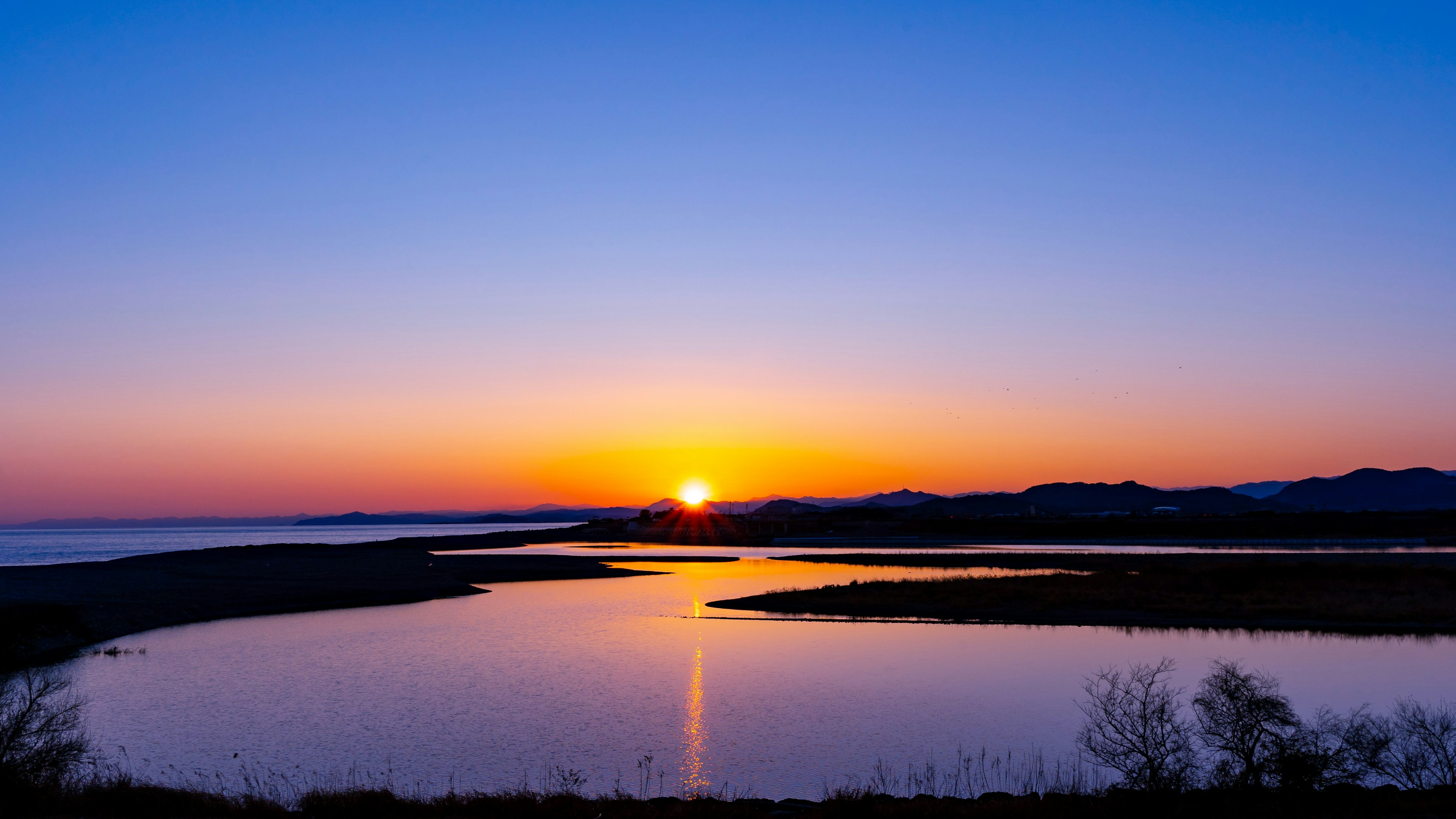 Scenic view of a lake during sunset with vibrant colors