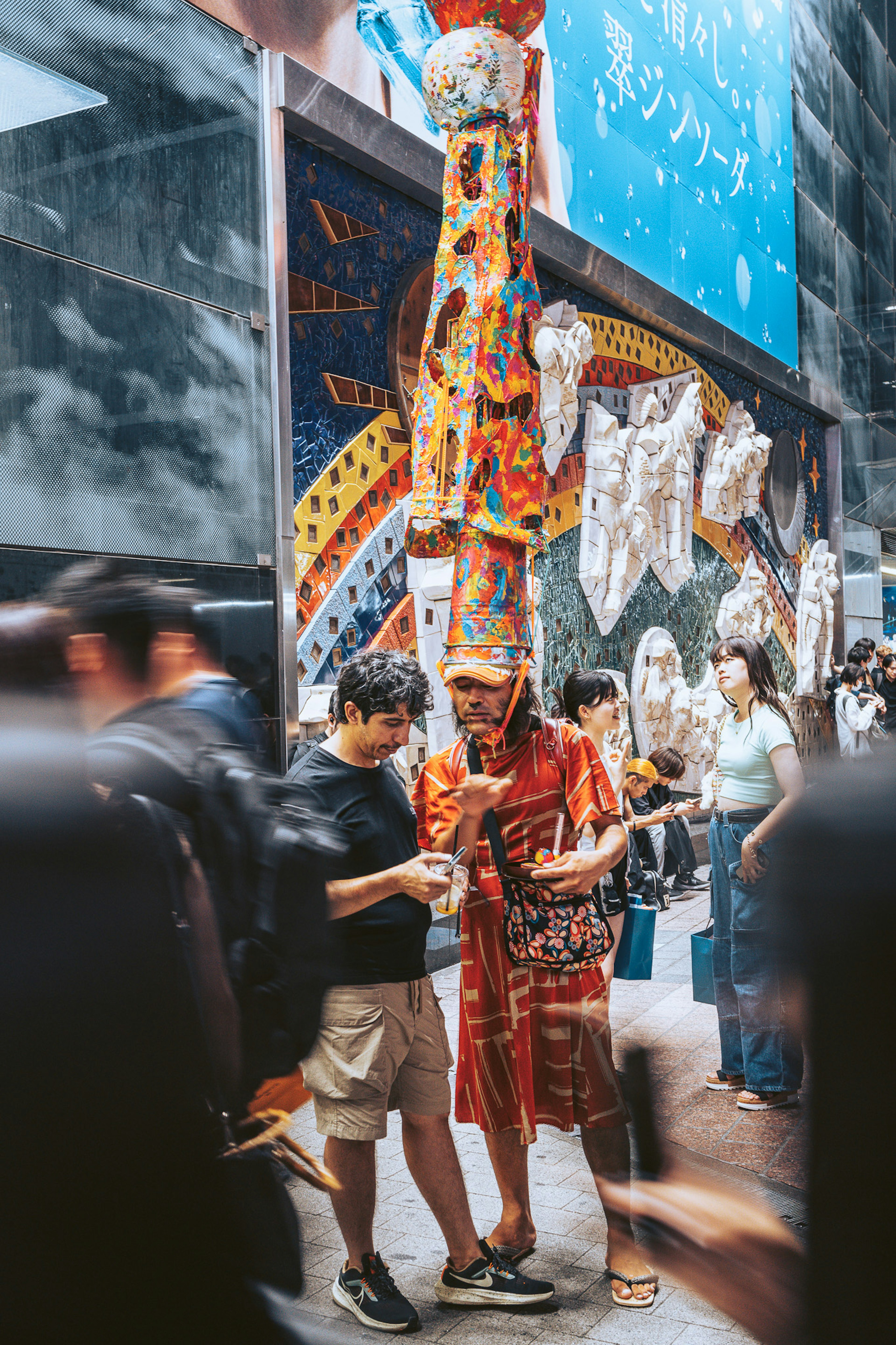 People in festival costumes walking through a crowded street