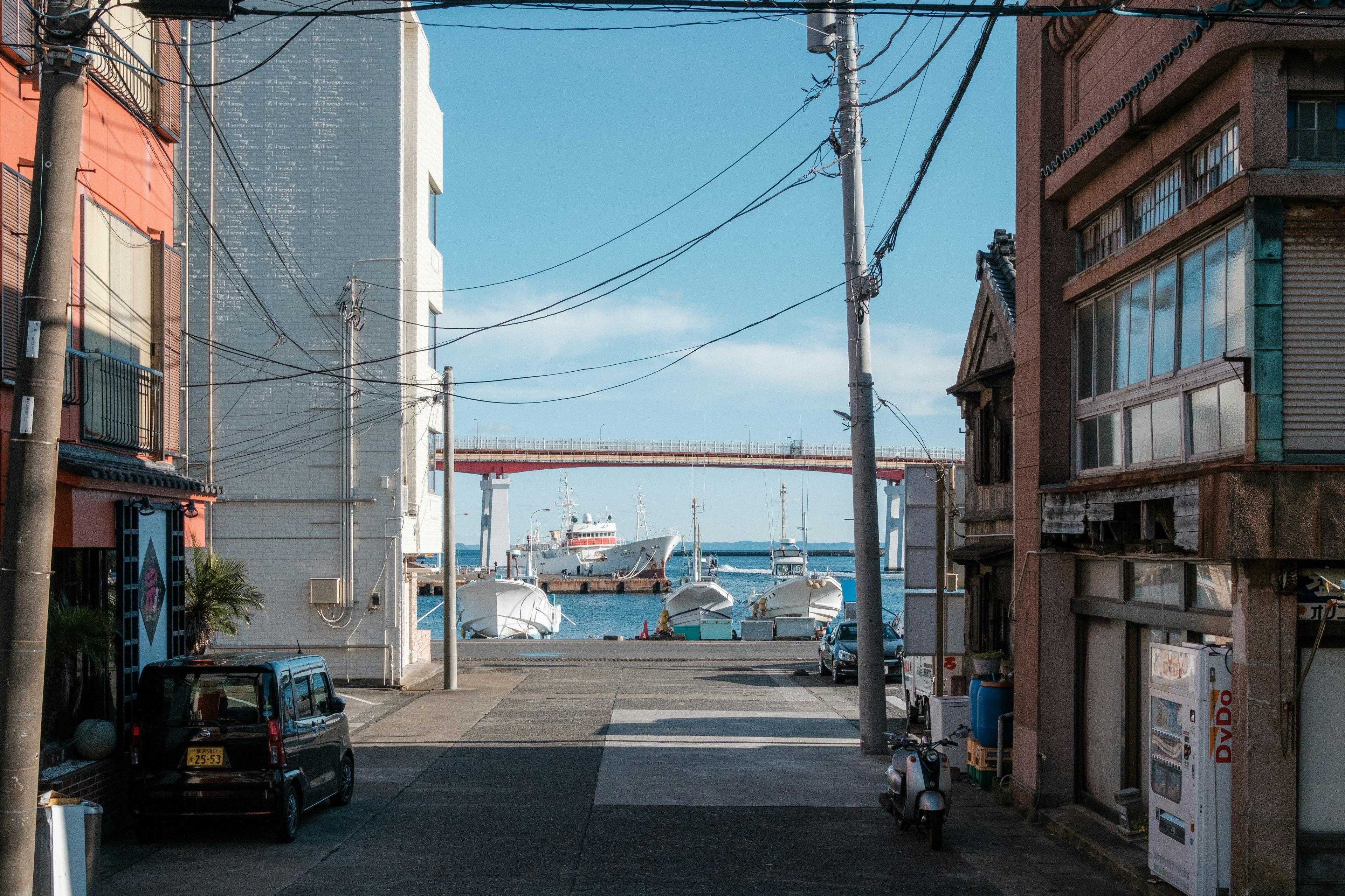 Street view featuring buildings and boats by the sea