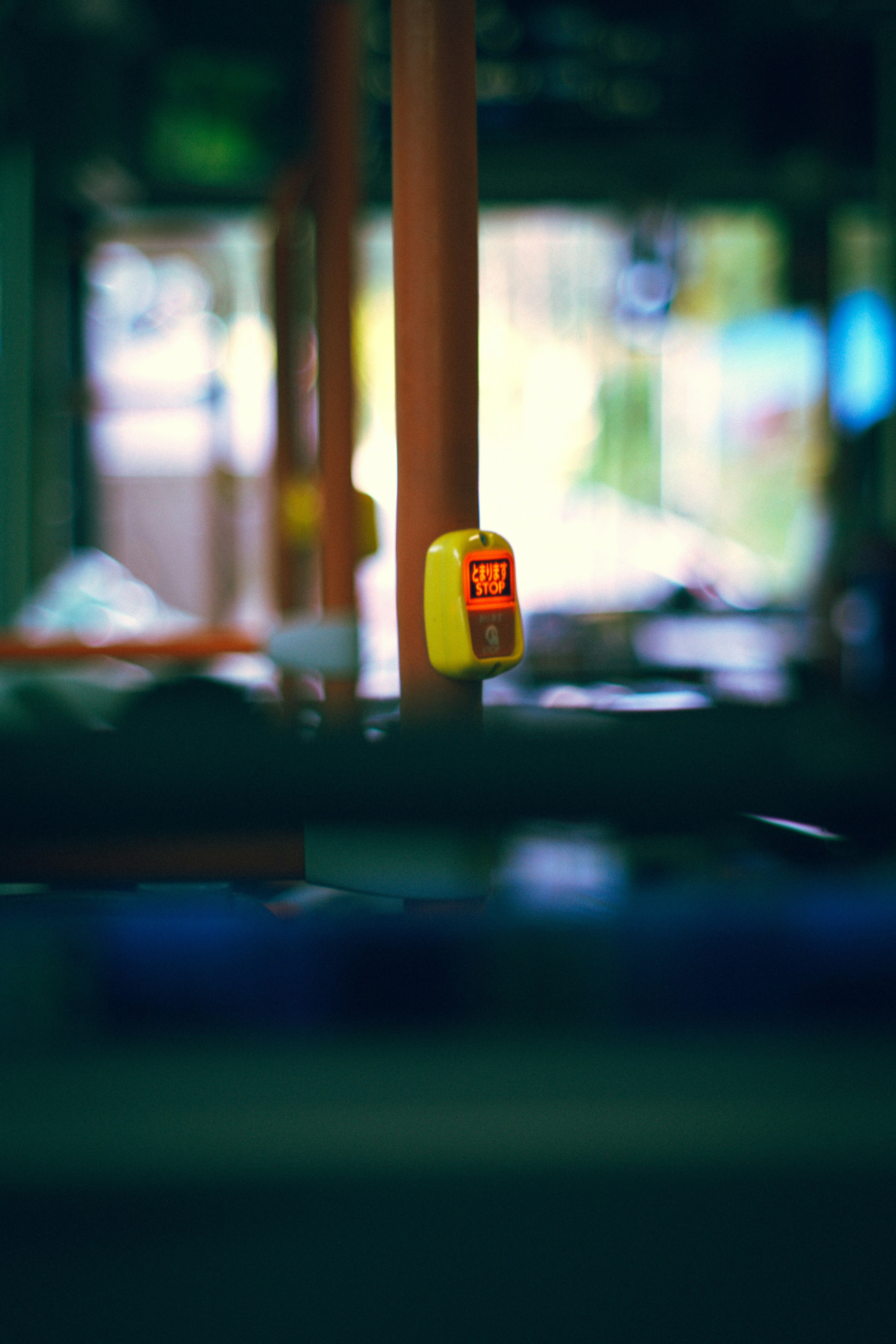 Image focusing on a yellow button inside a bus