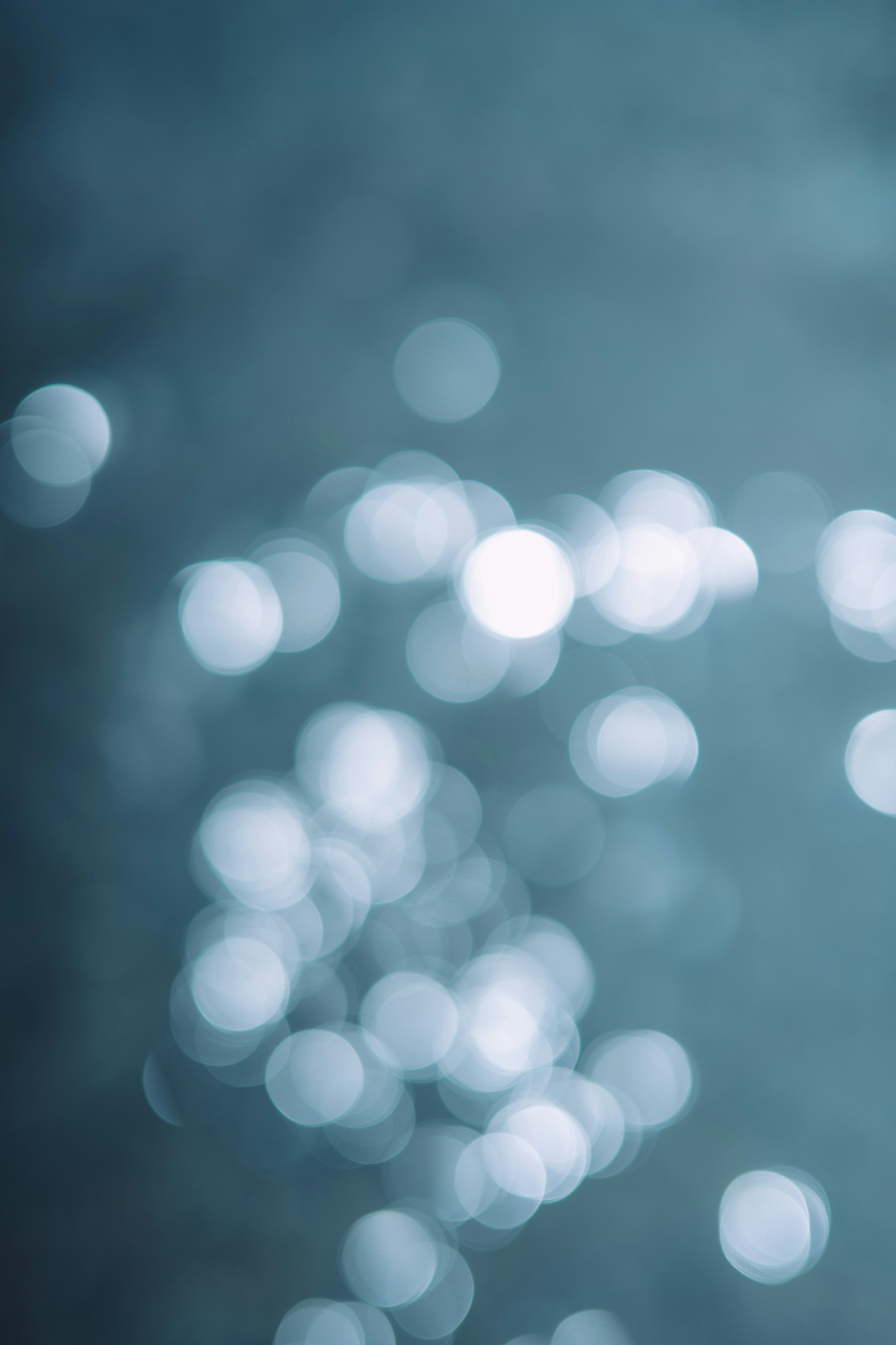 Blurred reflections of light on a blue water surface