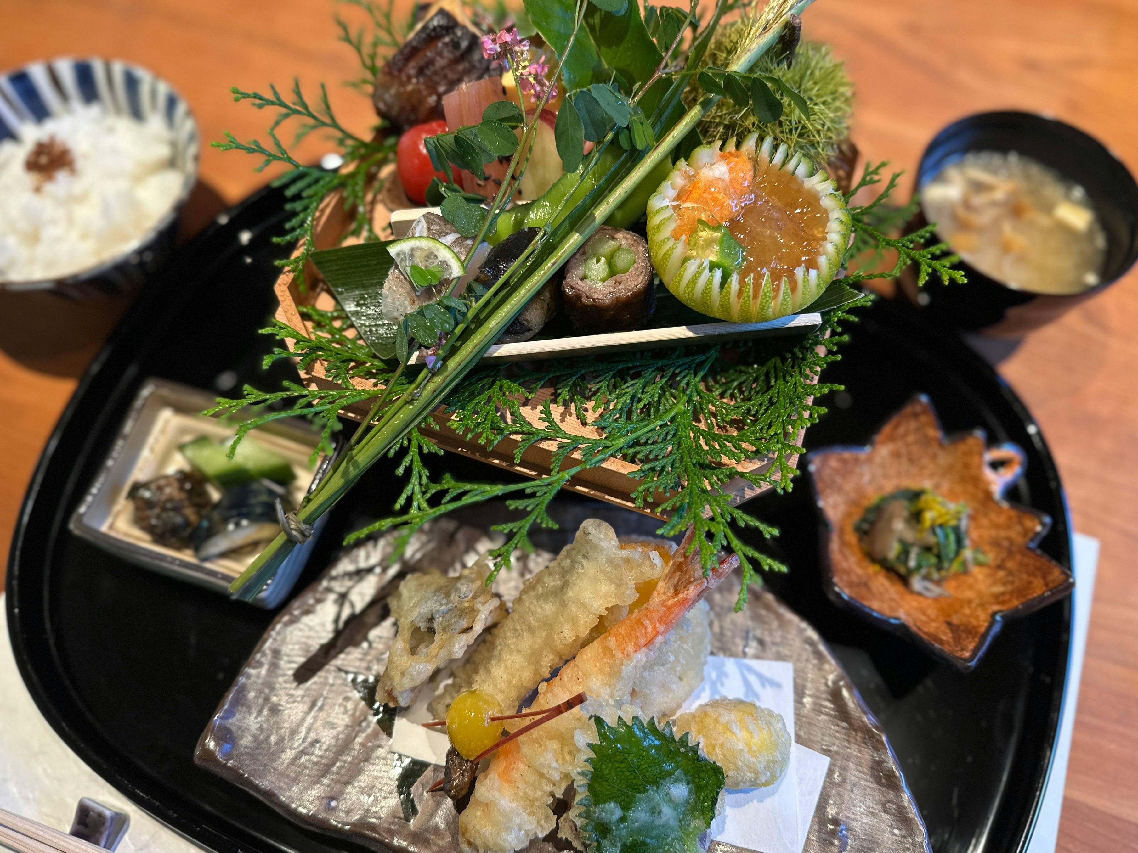 Beautifully arranged Japanese cuisine featuring tempura and fresh vegetables