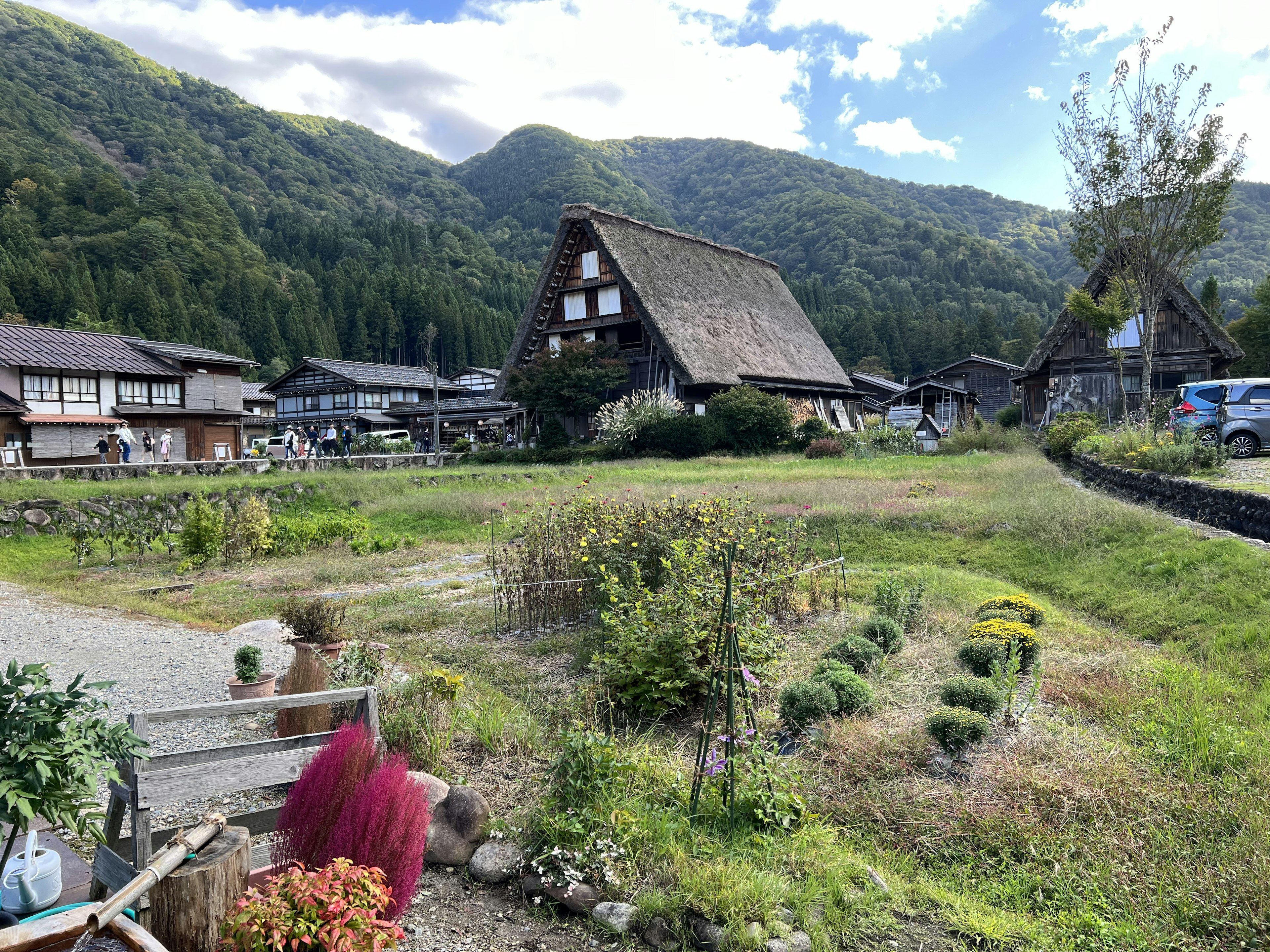 Scenic view of traditional thatched-roof houses surrounded by mountains