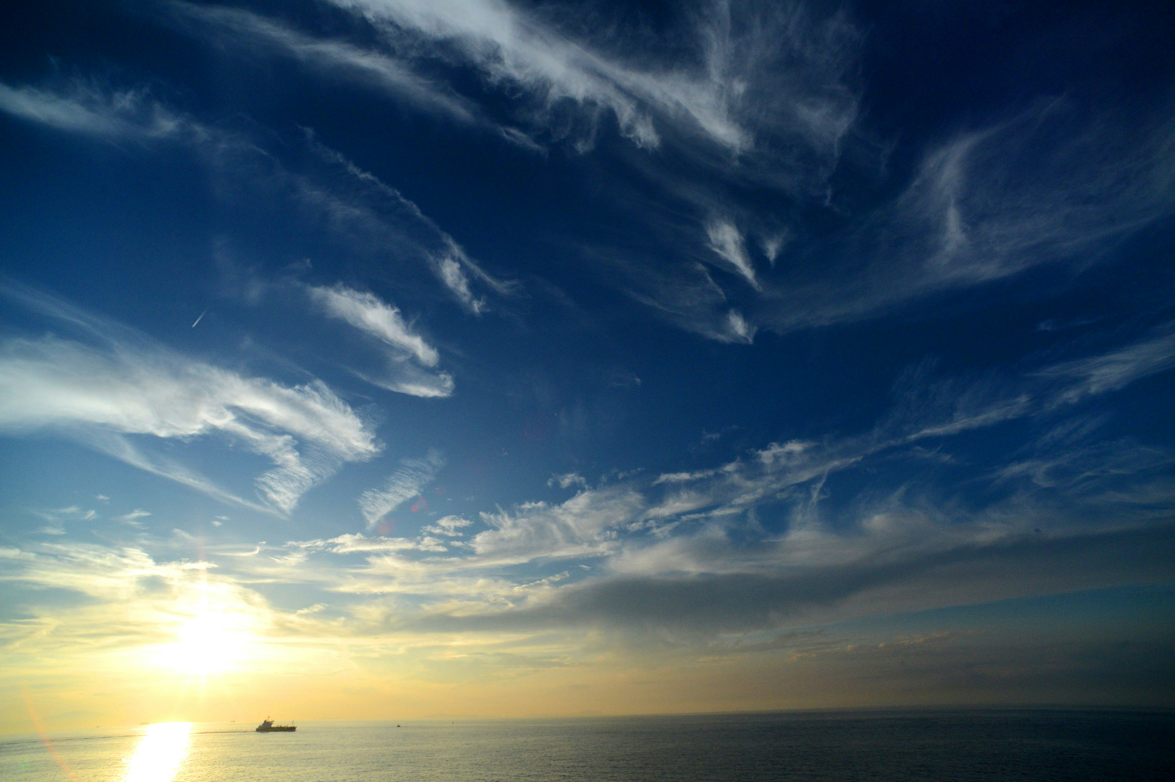 Beautiful seascape with blue sky and wispy white clouds