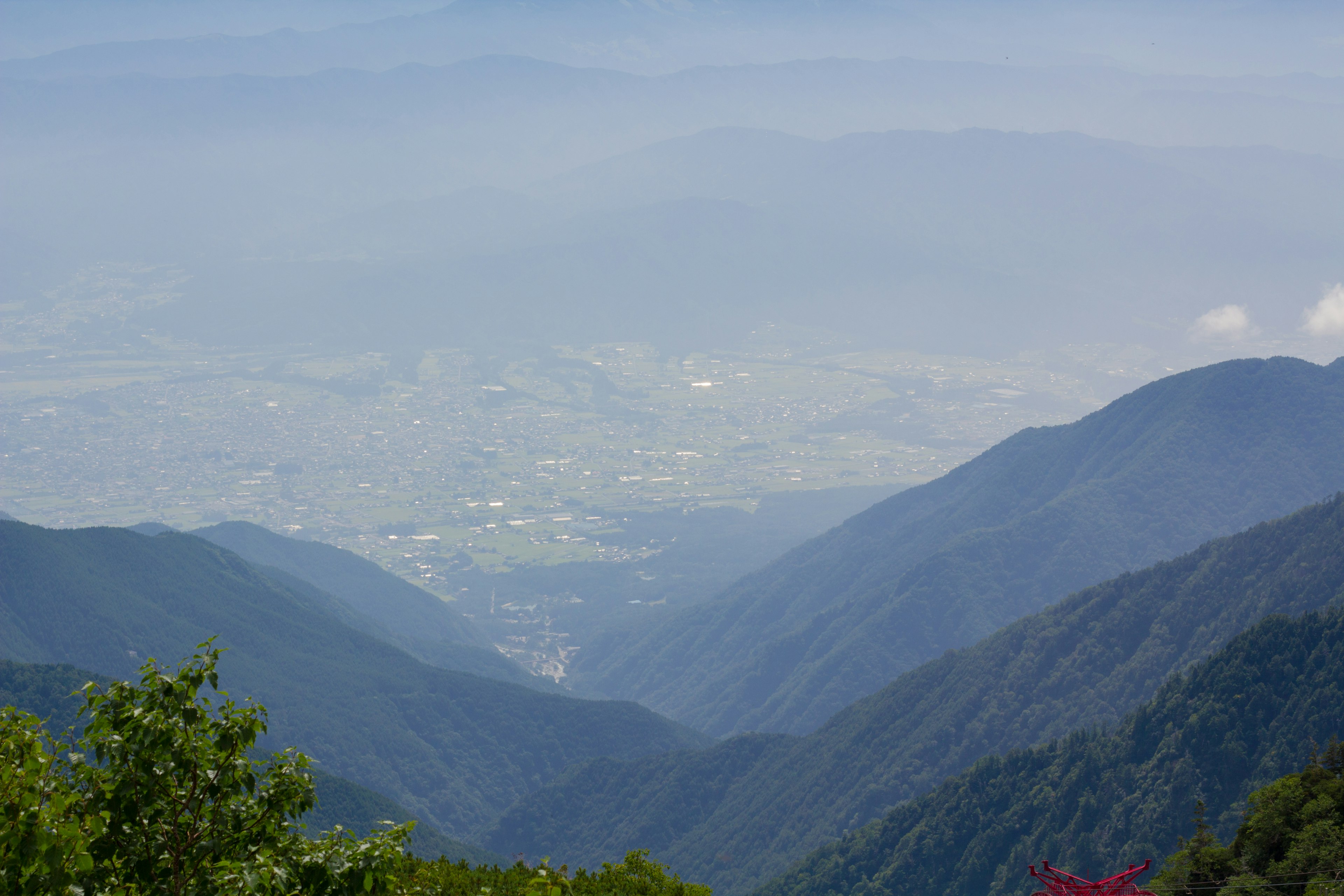 View of valleys and cityscape between mountains