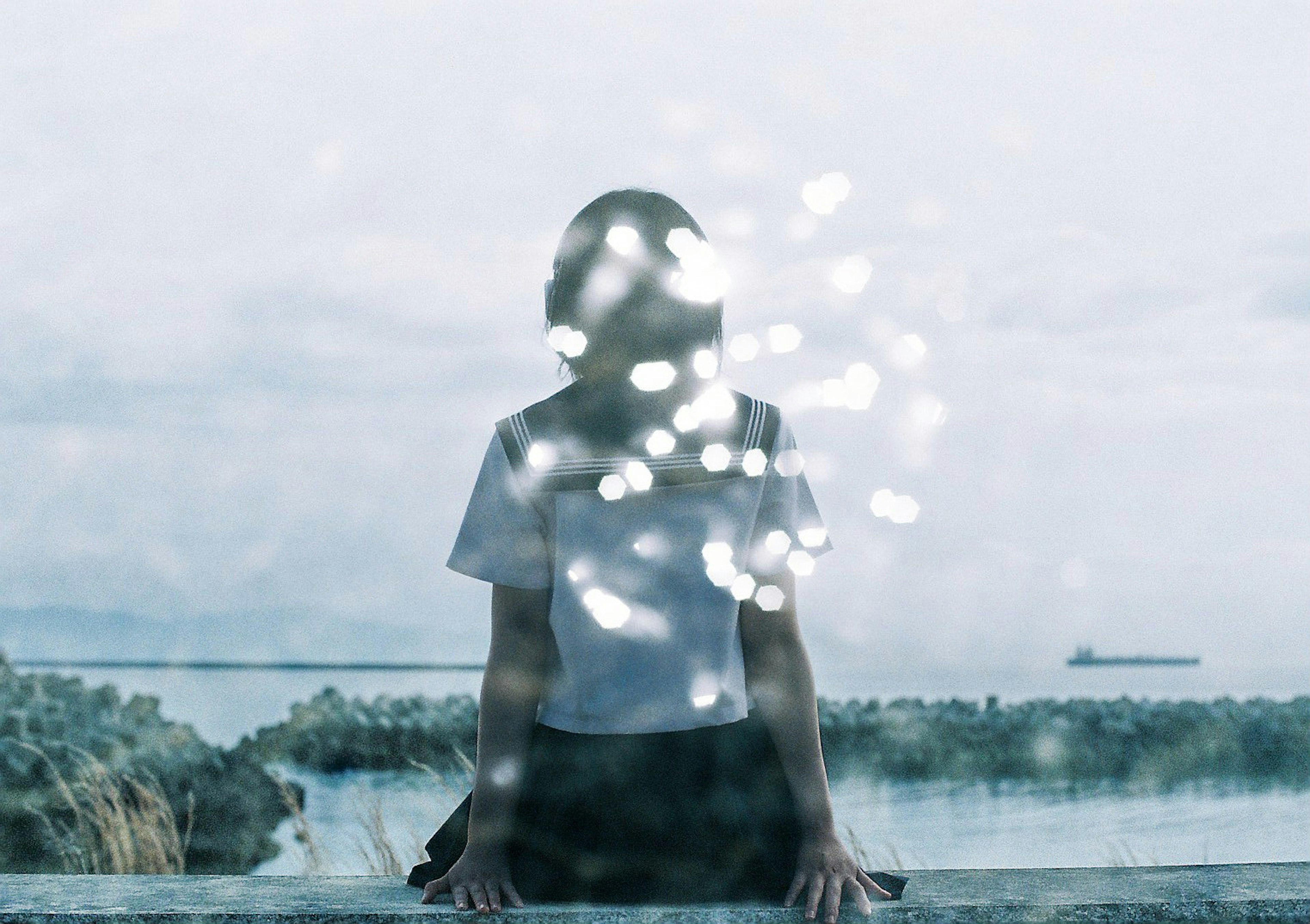 Silhouette of a girl against the sea background Beautiful light reflections