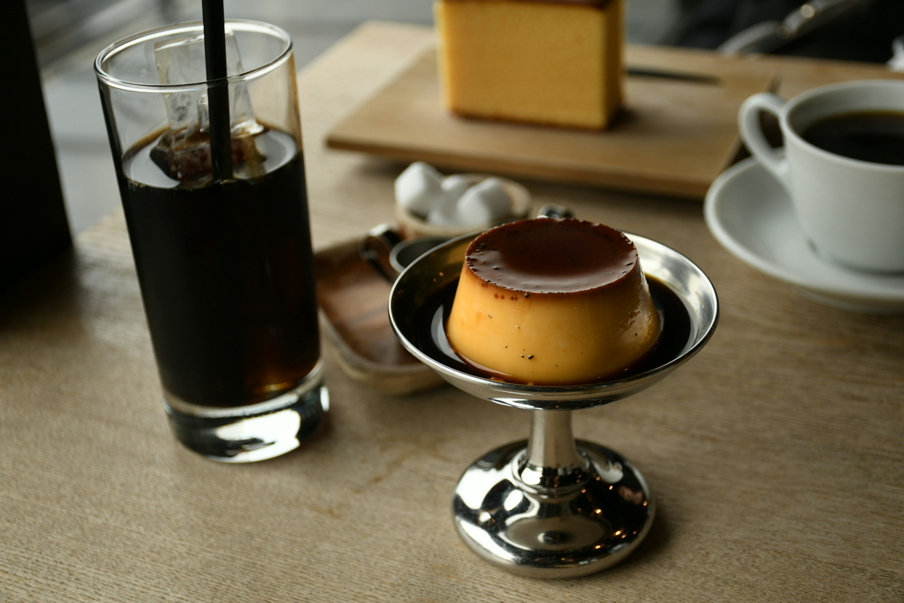 Cafe table with coffee and custard pudding