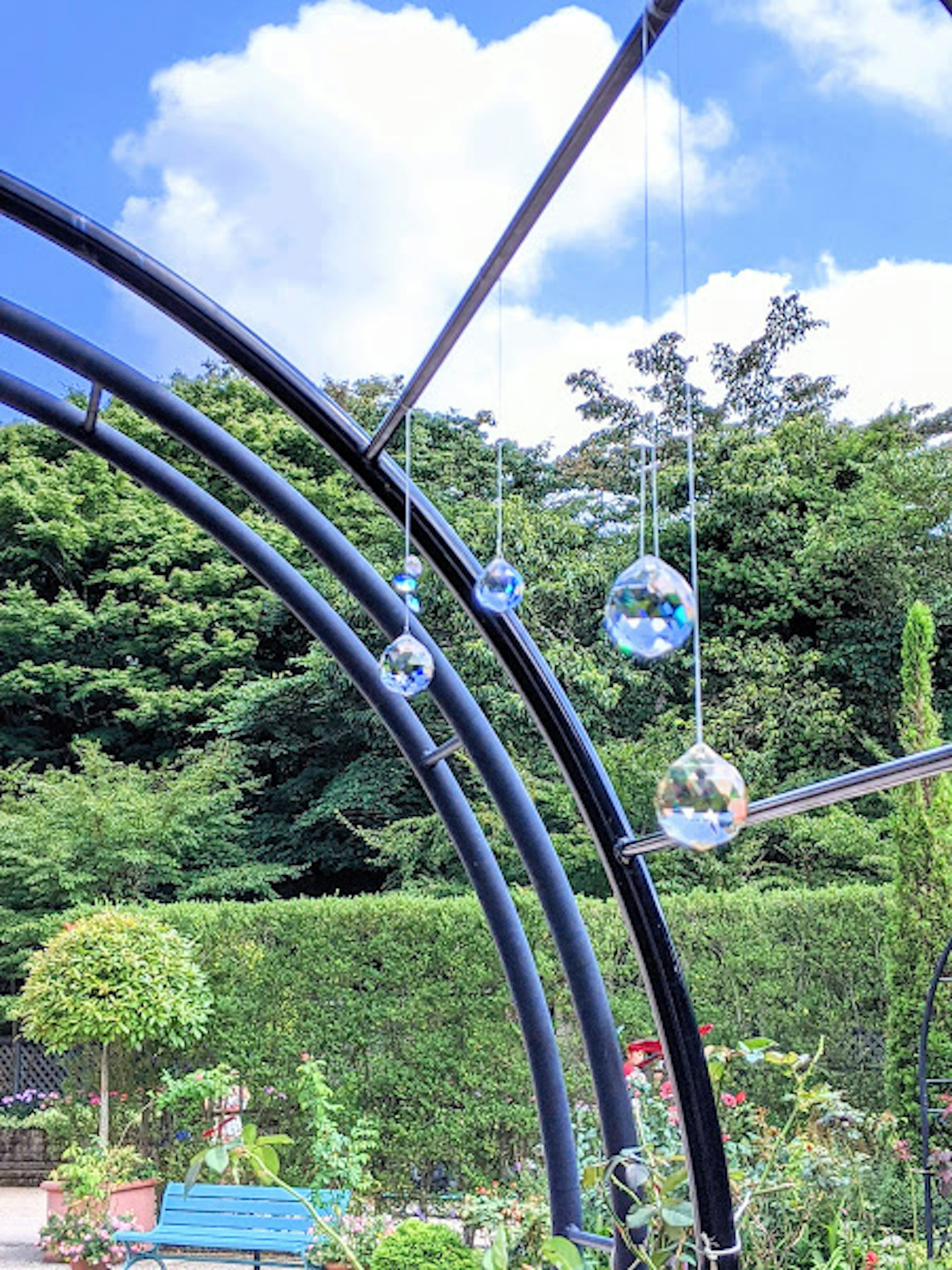 Park scene featuring arches and hanging crystal balls