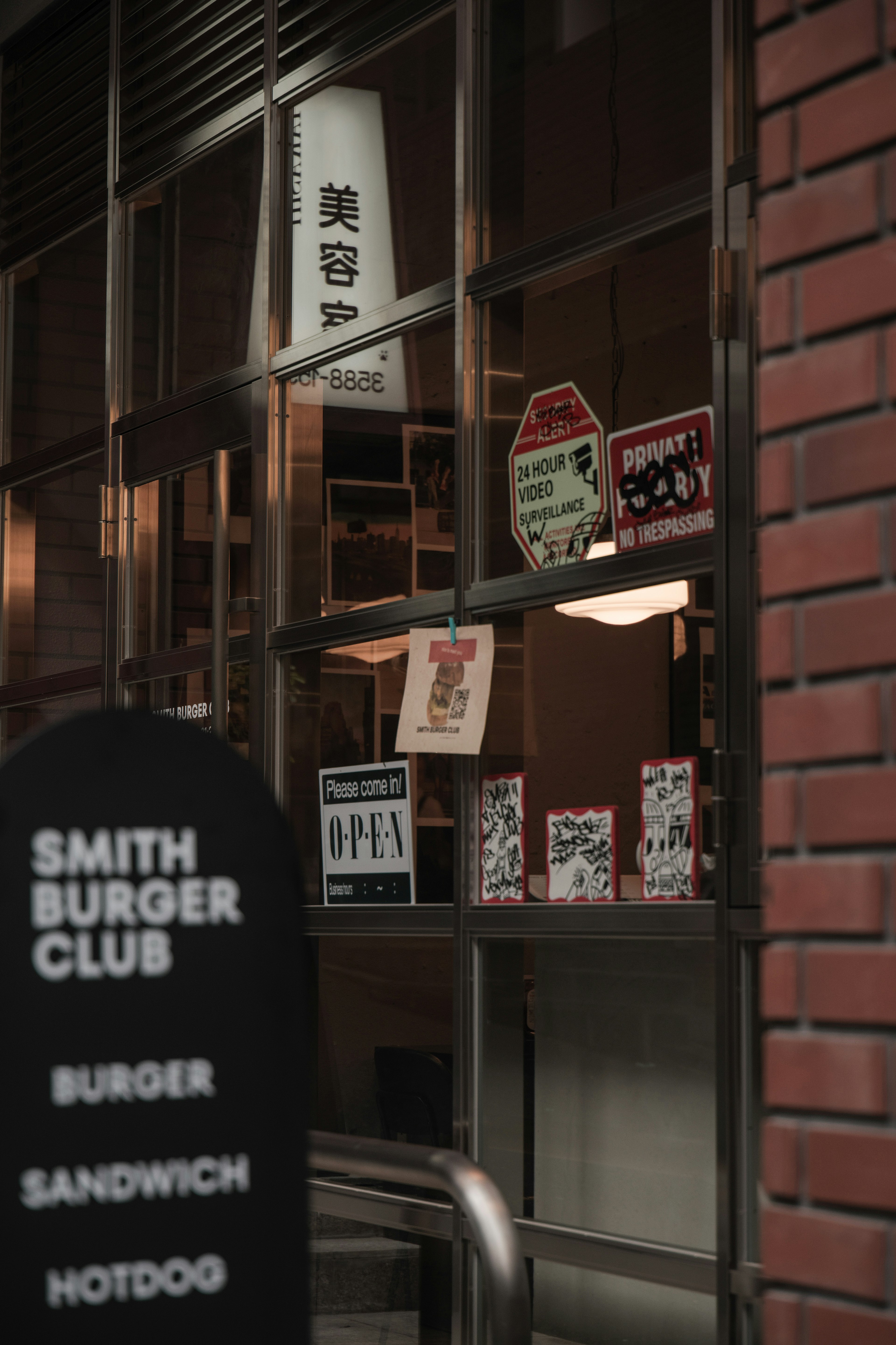 Exterior of Smith Burger Club featuring various menu signs