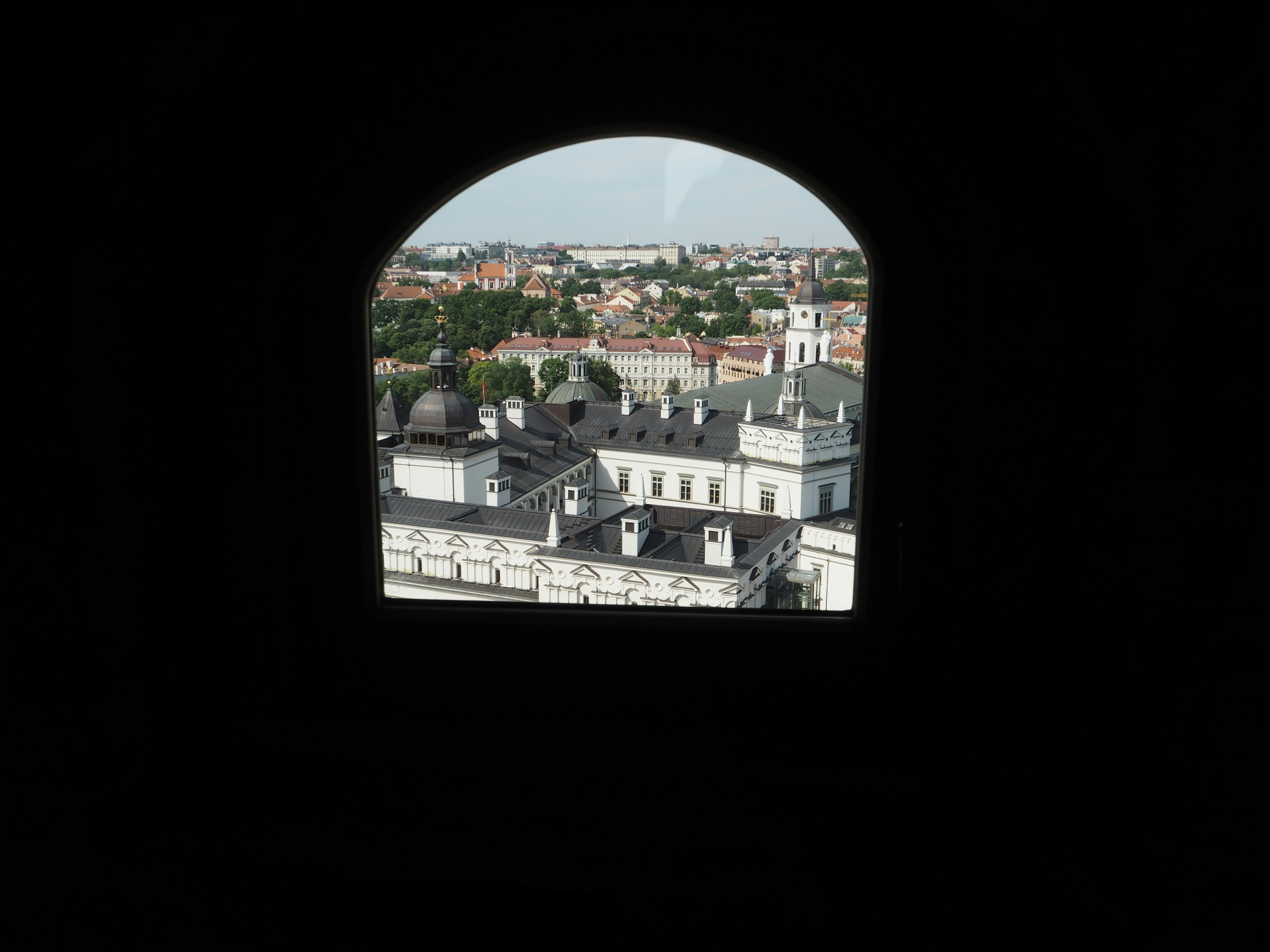 Vue sur les bâtiments de la ville à travers une fenêtre en arc