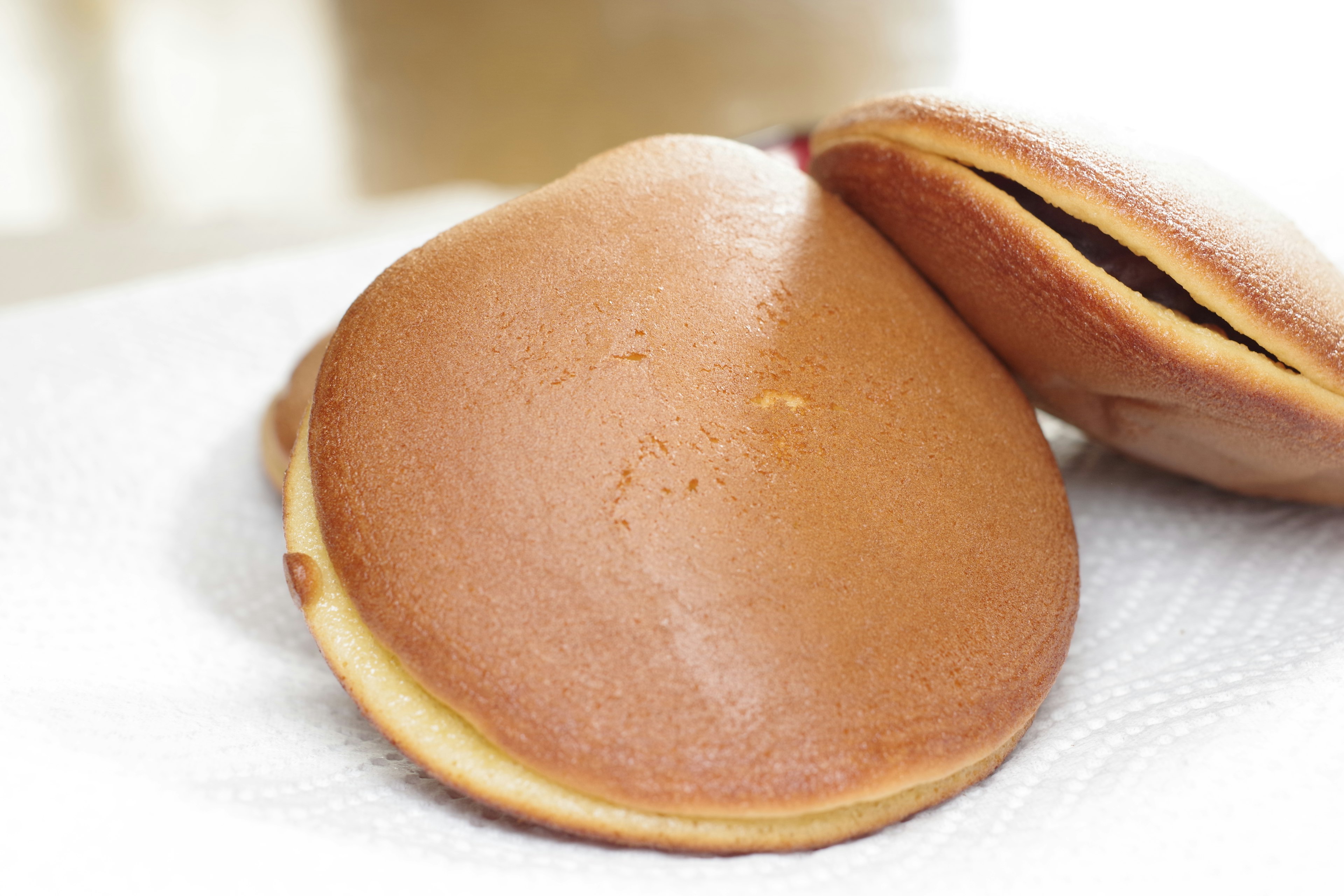 Two fluffy dorayaki placed on a white paper towel