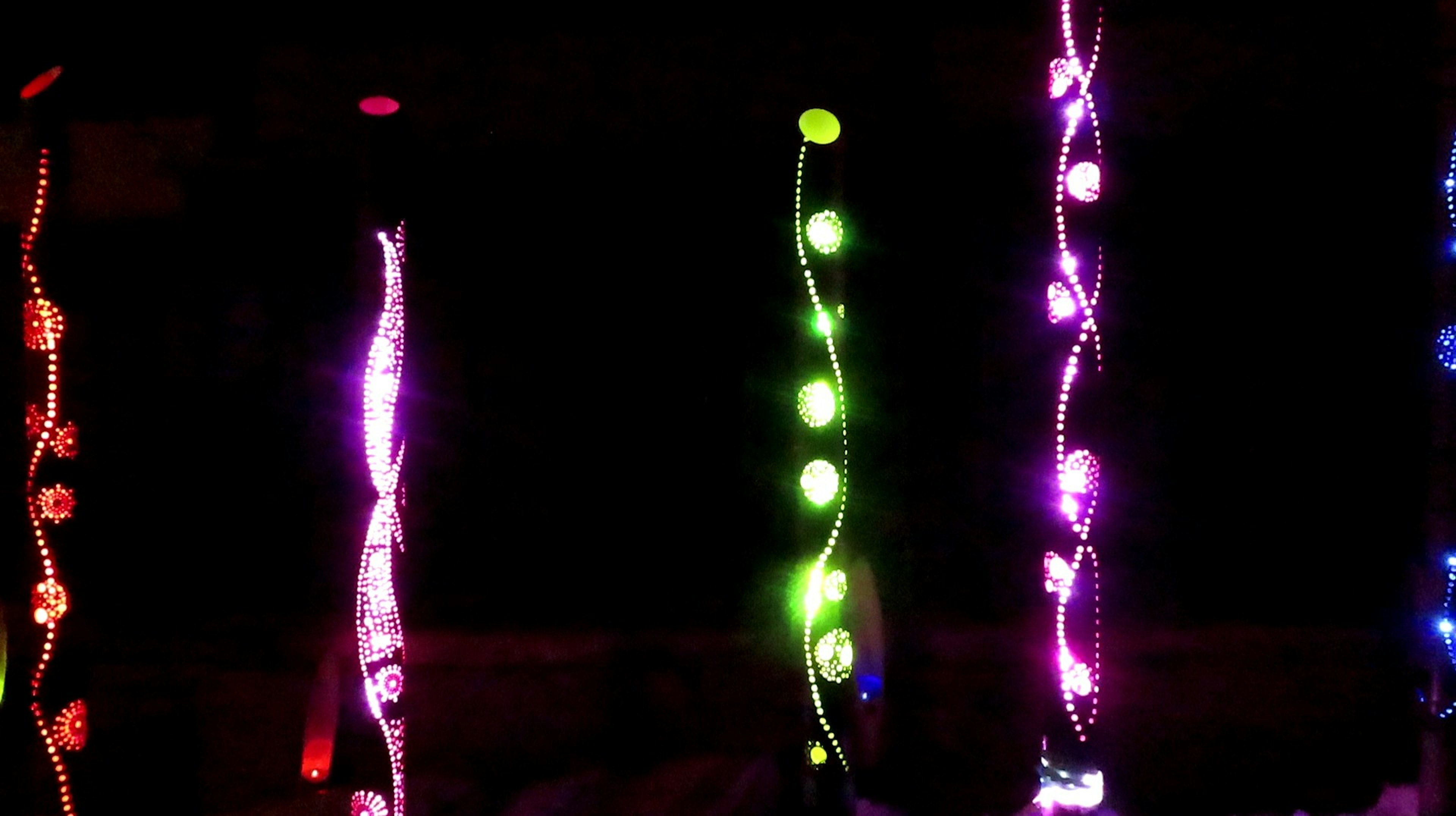 Colorful string lights glowing against a dark background