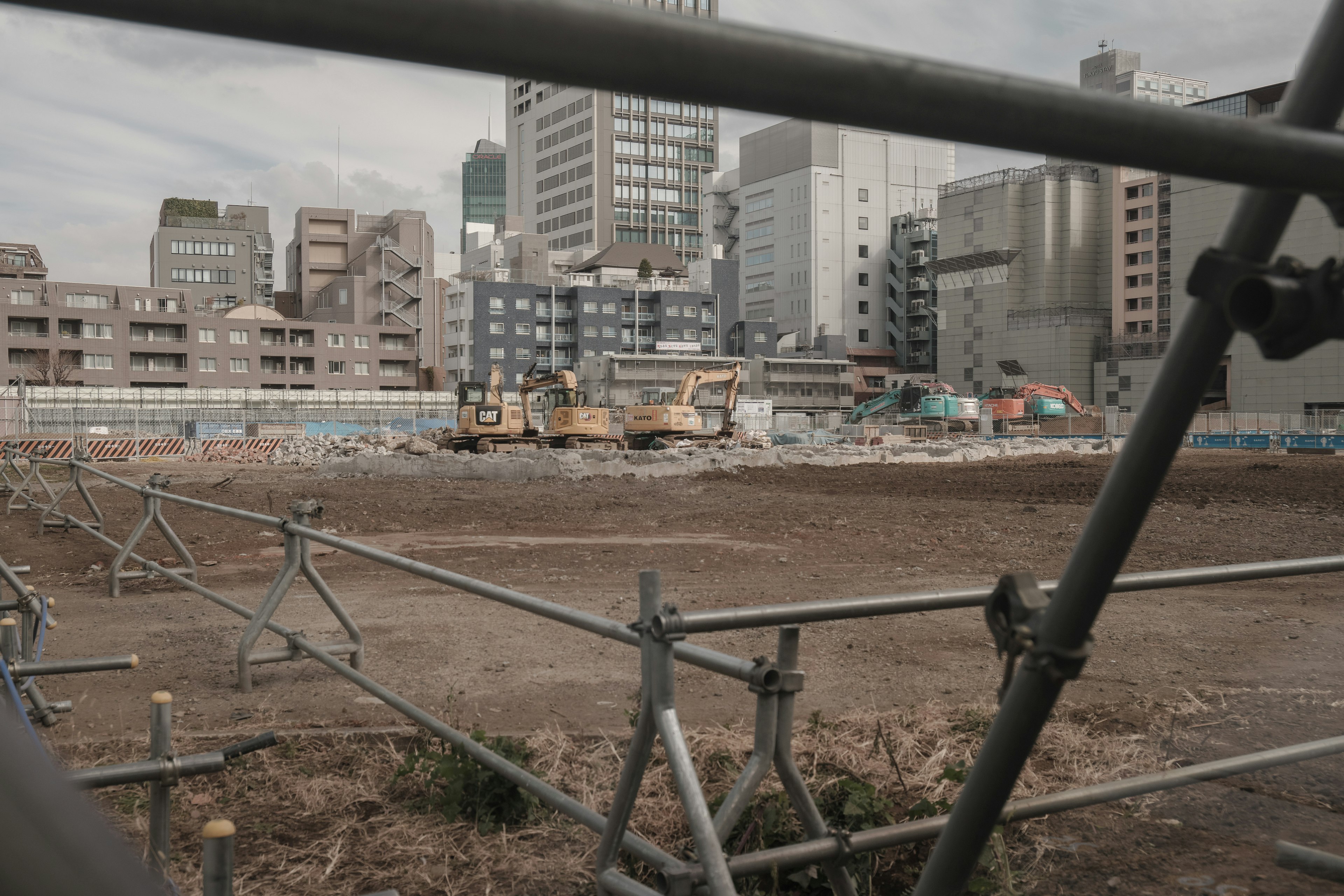 Construction site view featuring demolished buildings and machinery