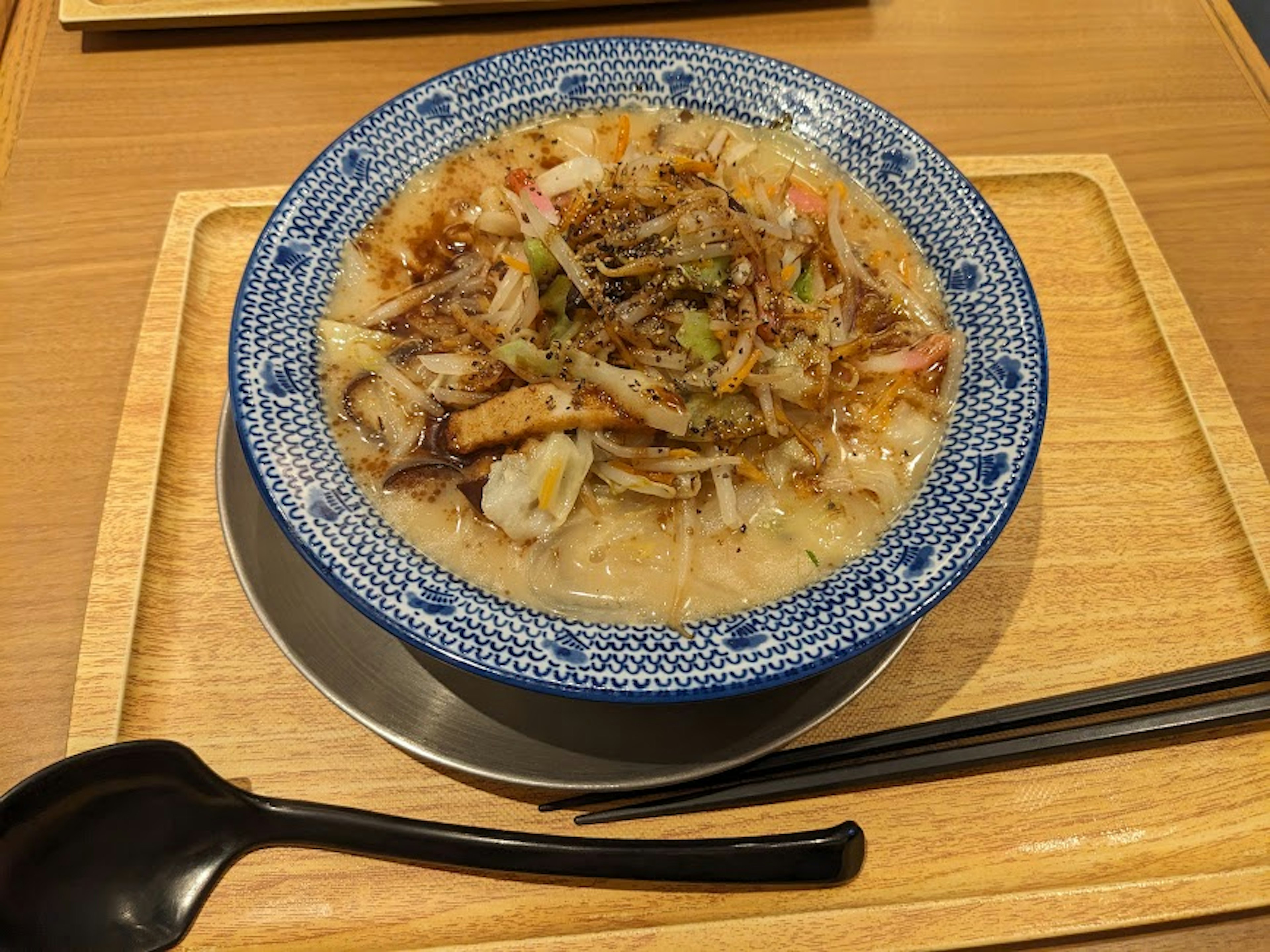 Image of seafood ramen in a blue rimmed bowl