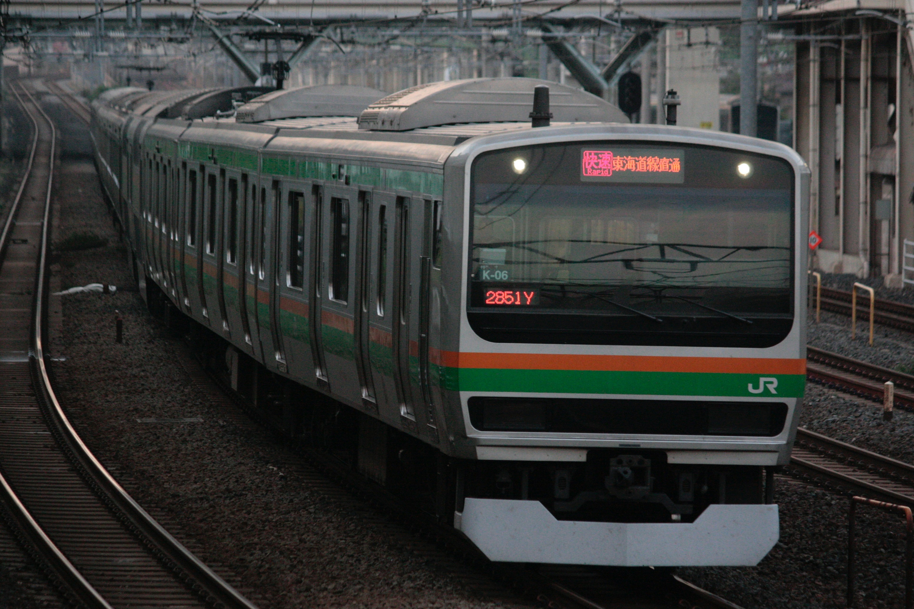 Green and orange JR train stopped on the tracks