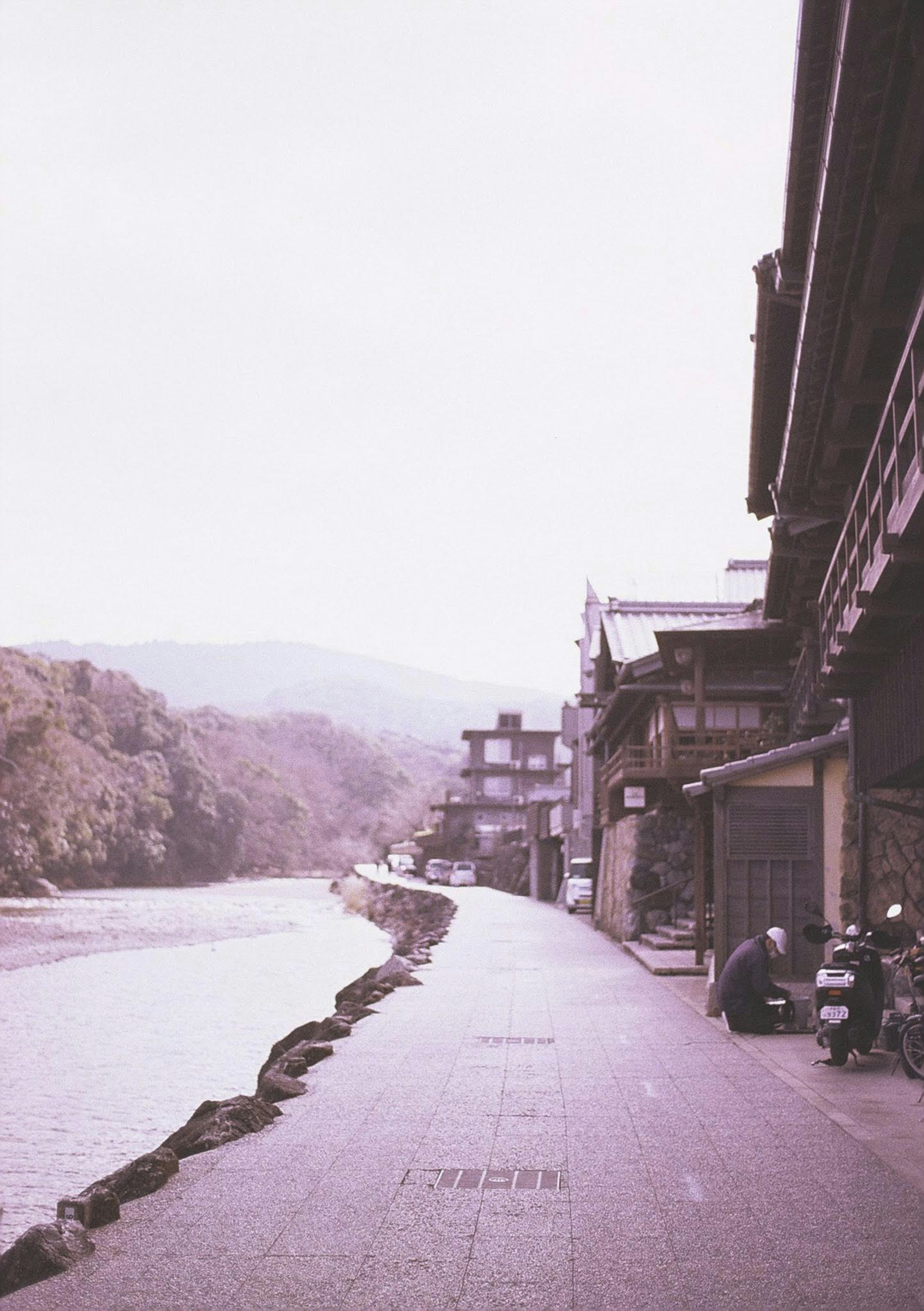 Quiet riverside road with old buildings lining the view