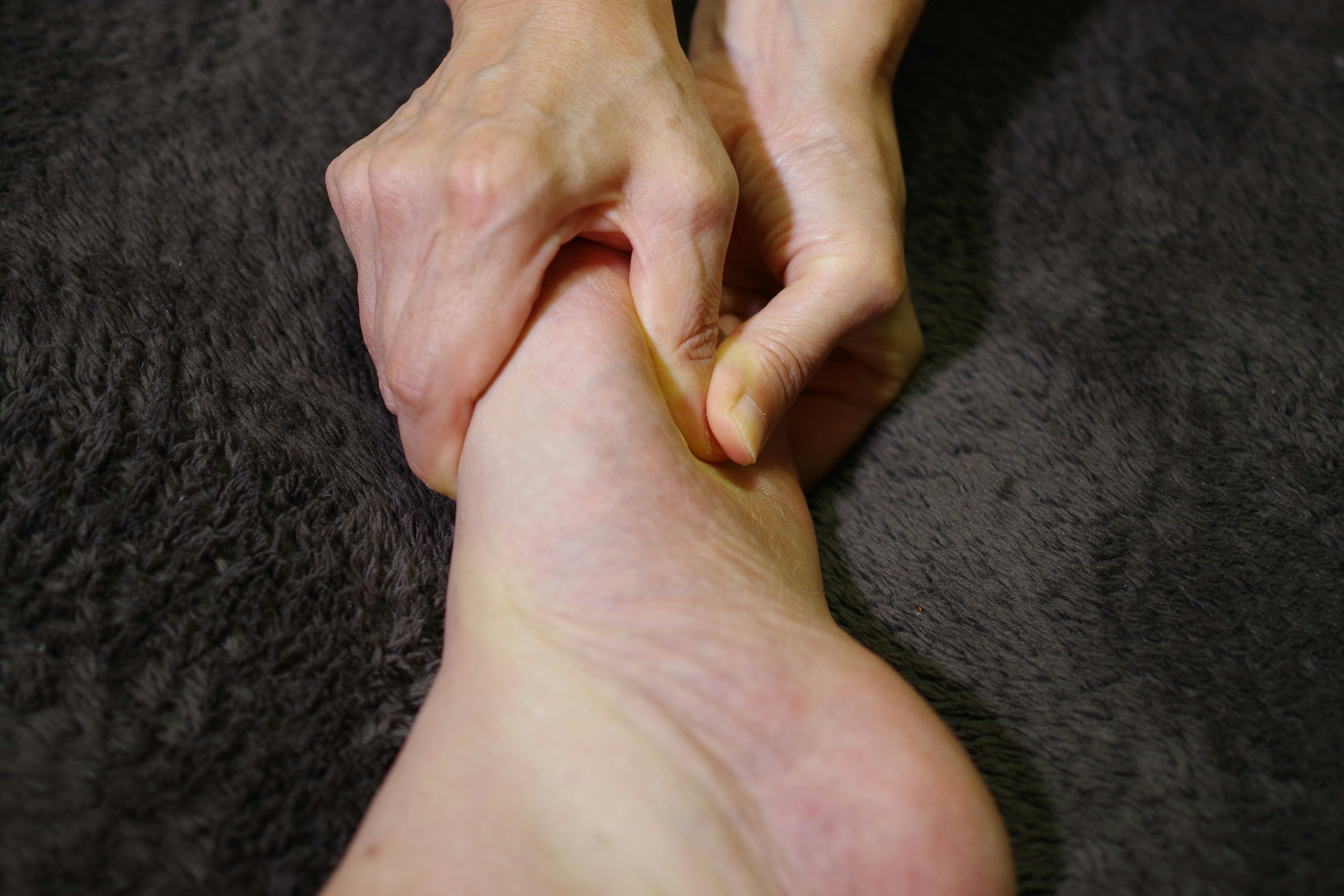 Close-up of hands pinching an ankle