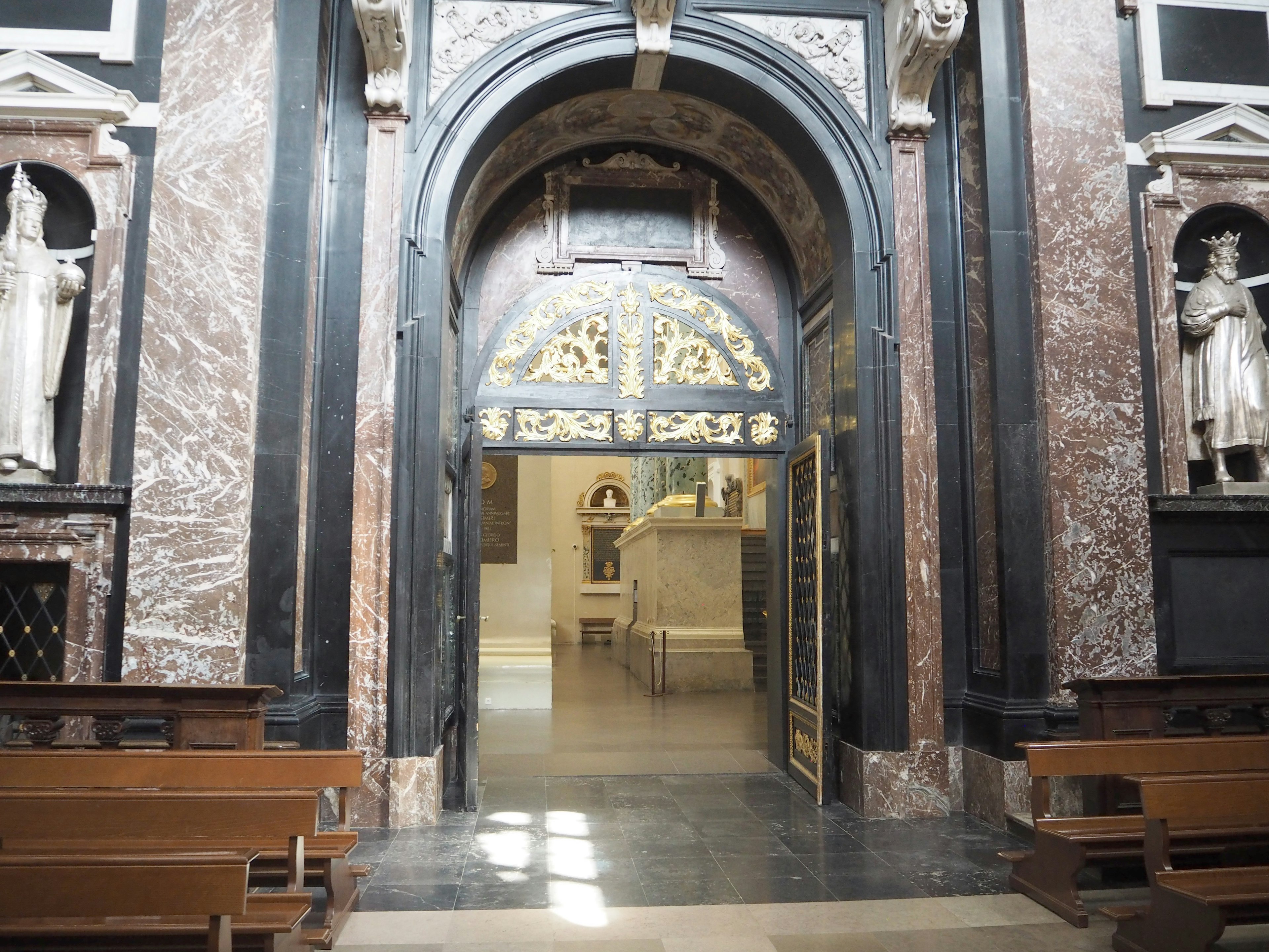 Innere einer Kirche mit einem gewölbten Eingang und skulptierten Figuren