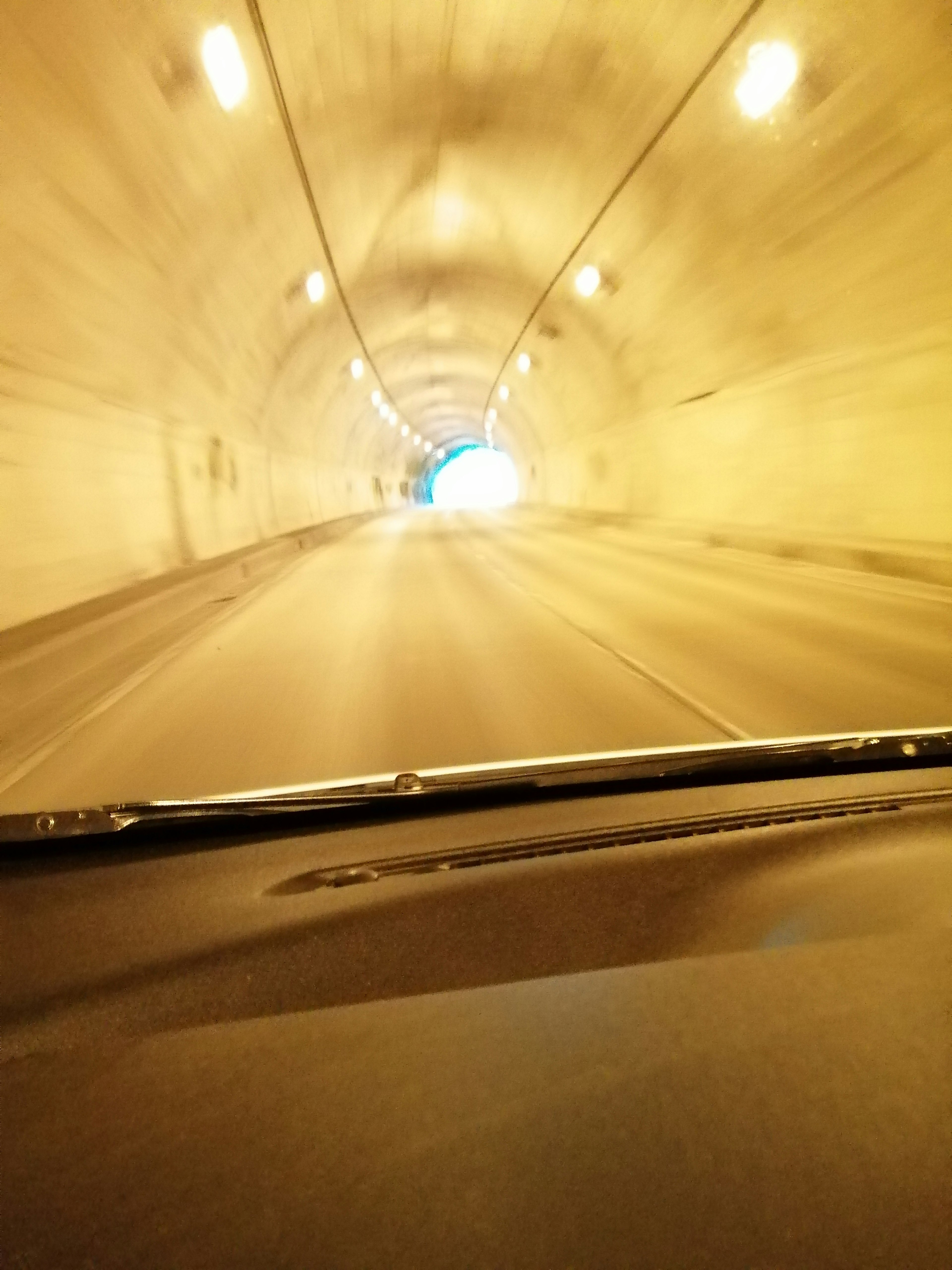 View inside a tunnel with a bright exit in the distance