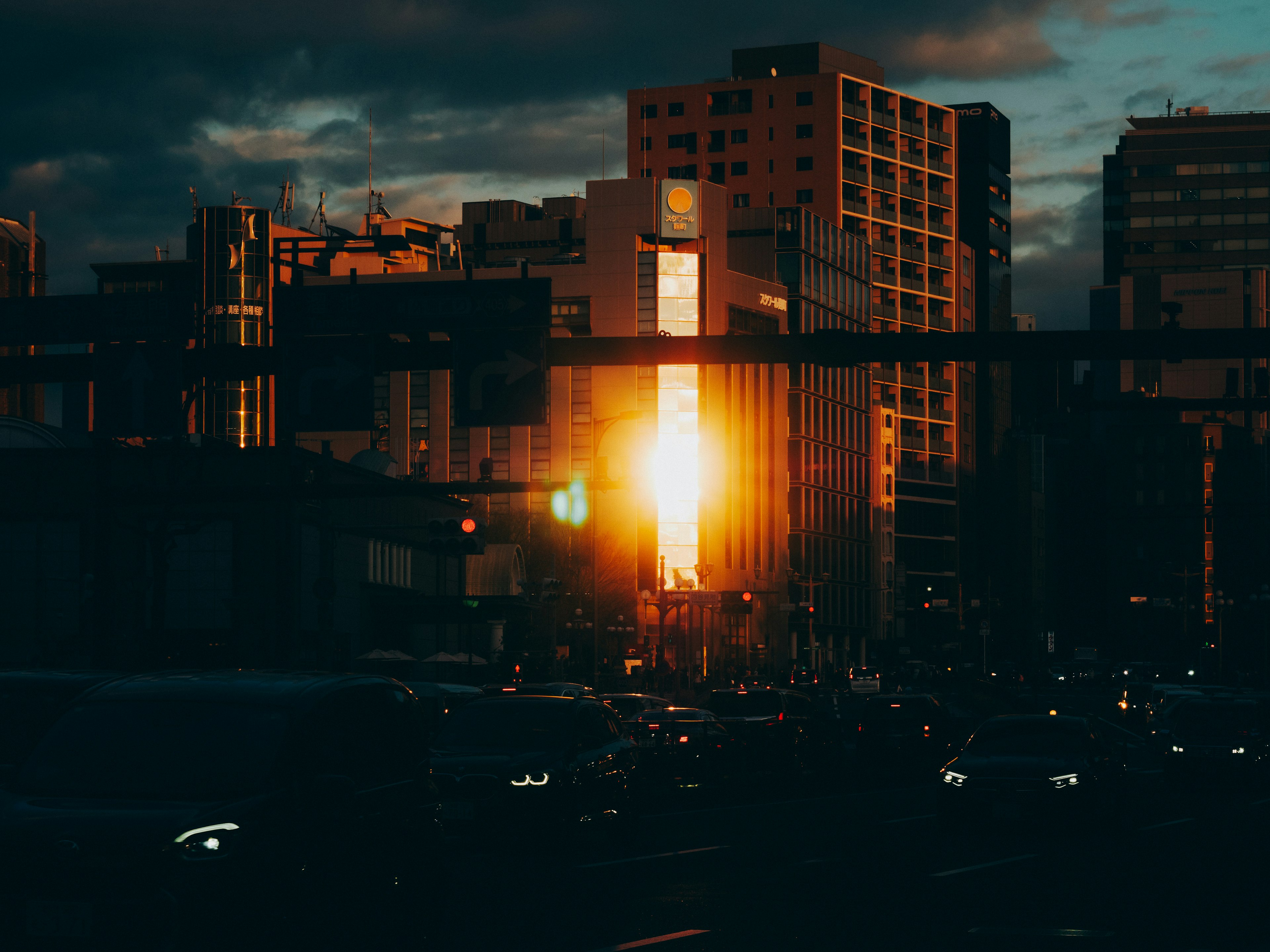 Cityscape at dusk with sunlight reflecting off buildings