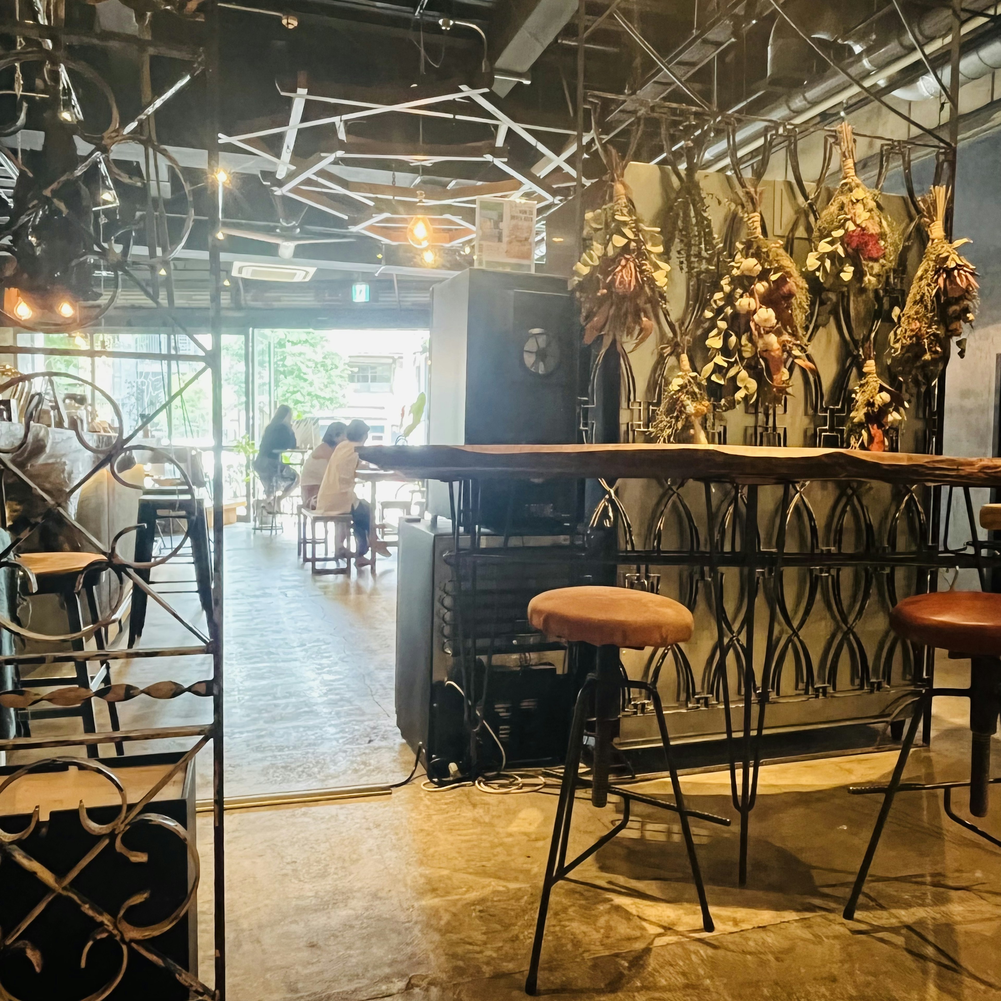 Interior design of a cafe stylish bar stools floral decorations industrial vibe