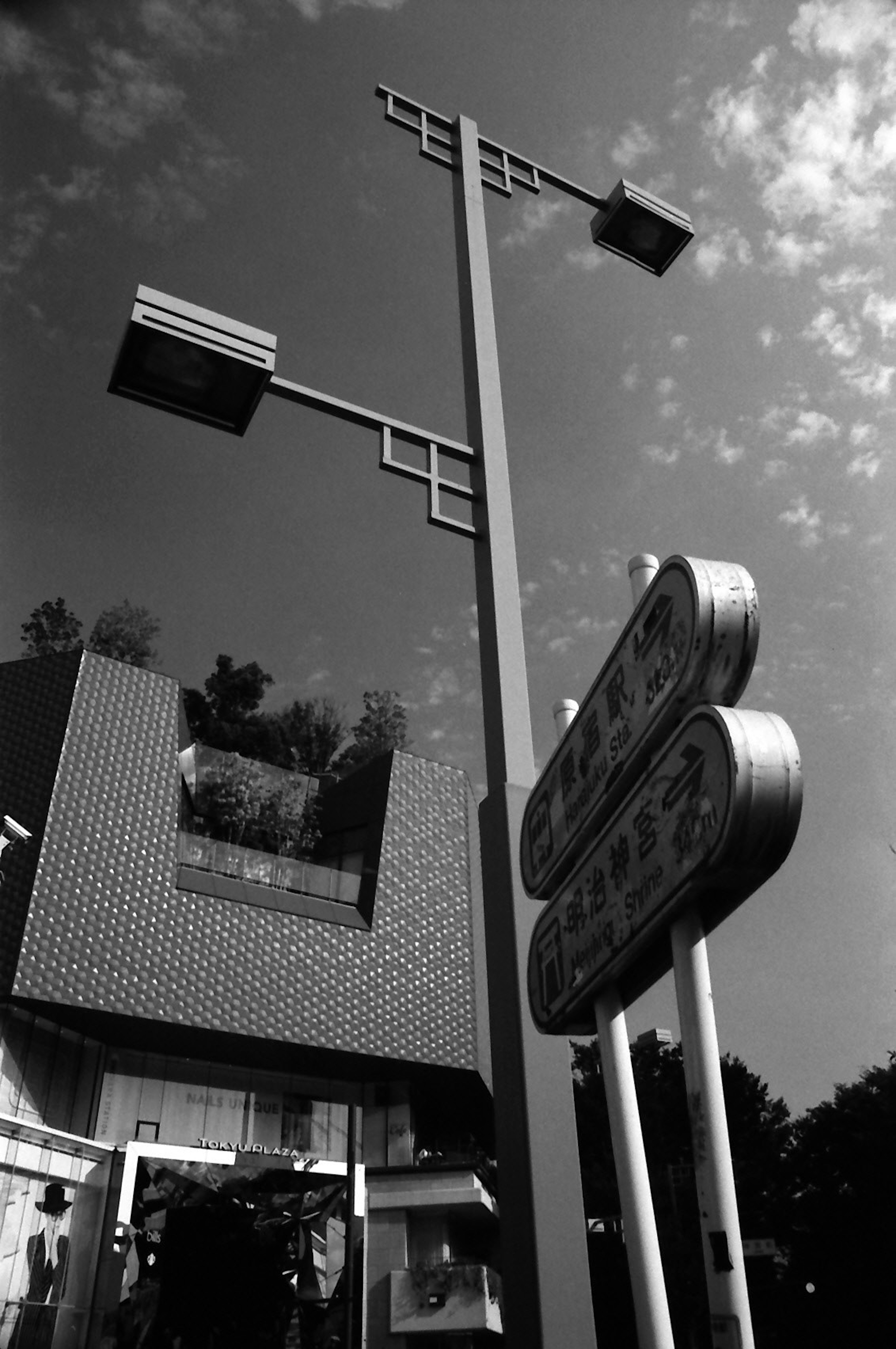 Urban scene with tall streetlights and signs Modern architecture contrasts with the sky