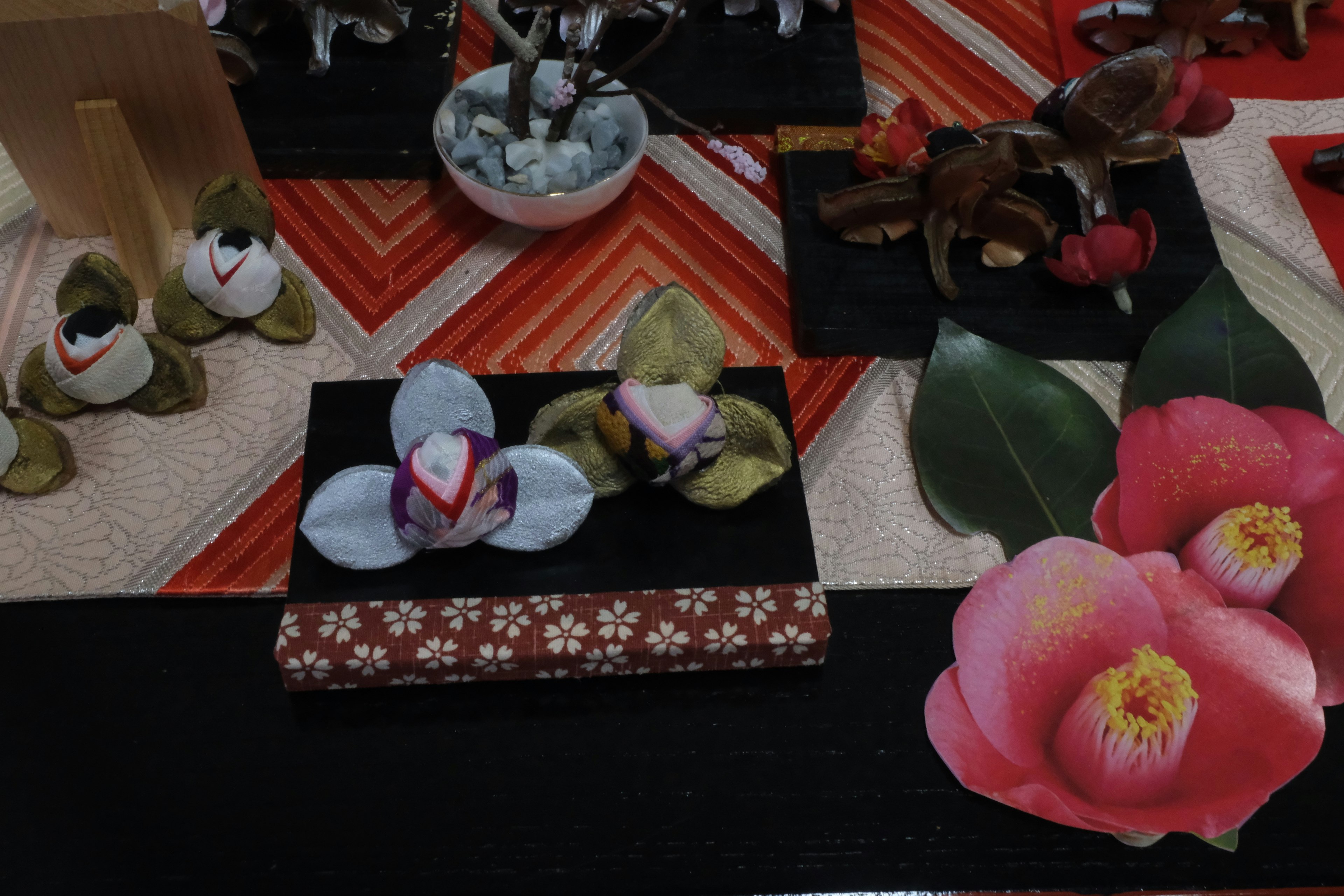 Image of a table adorned with various colorful flowers and handmade decorations