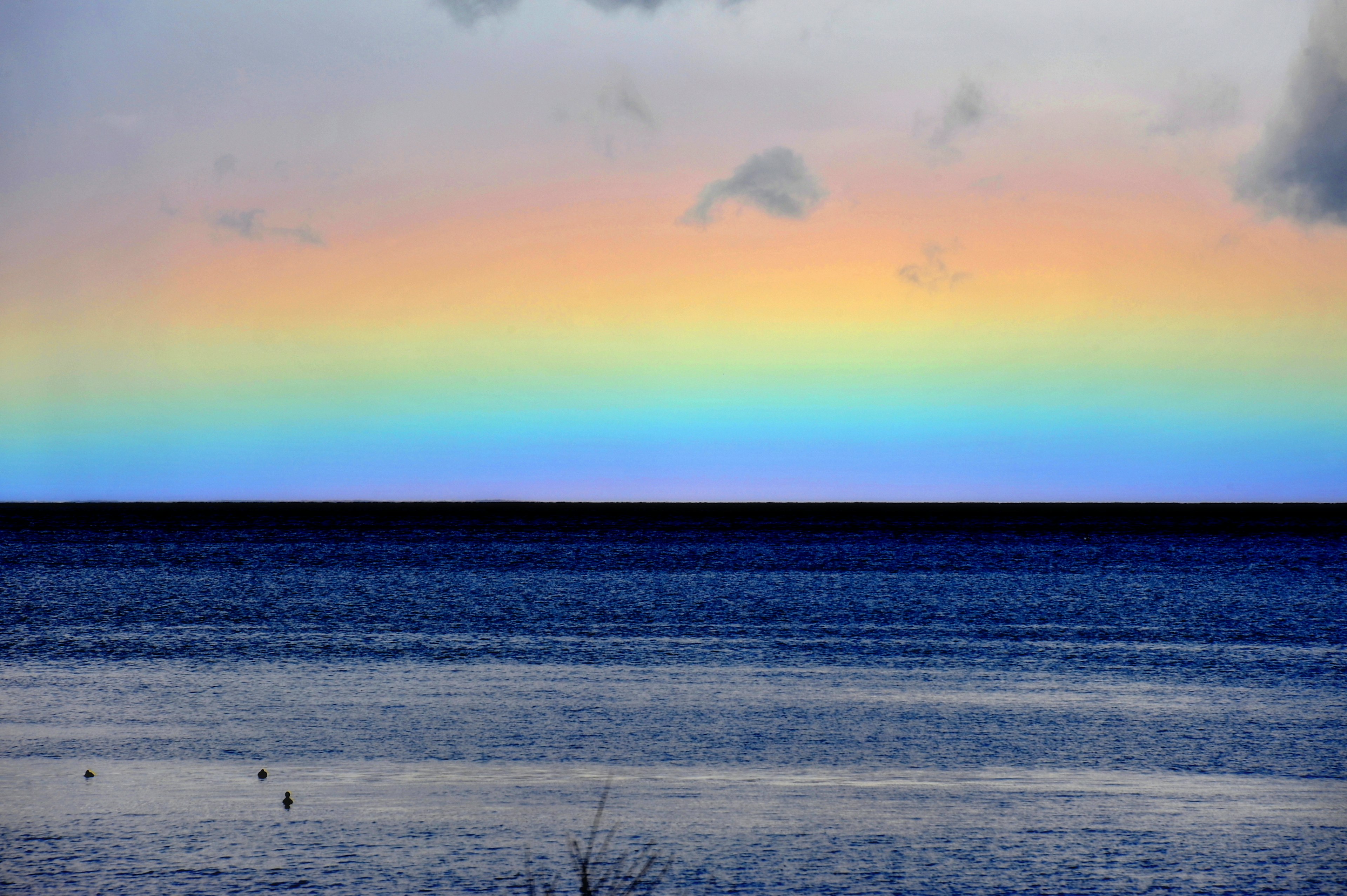 Beautiful seascape with a colorful rainbow sky