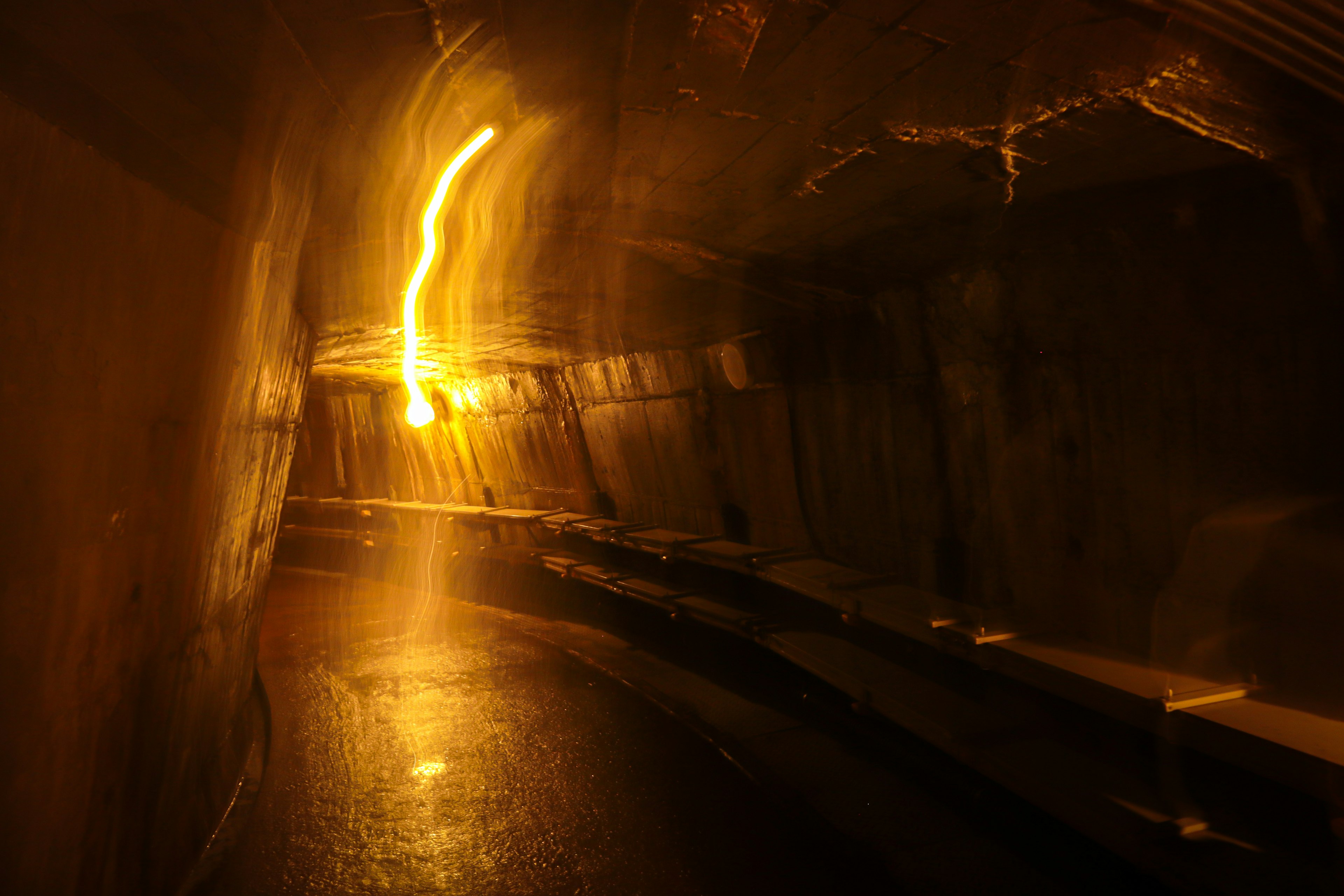 Dimly lit tunnel with a soft yellow glow