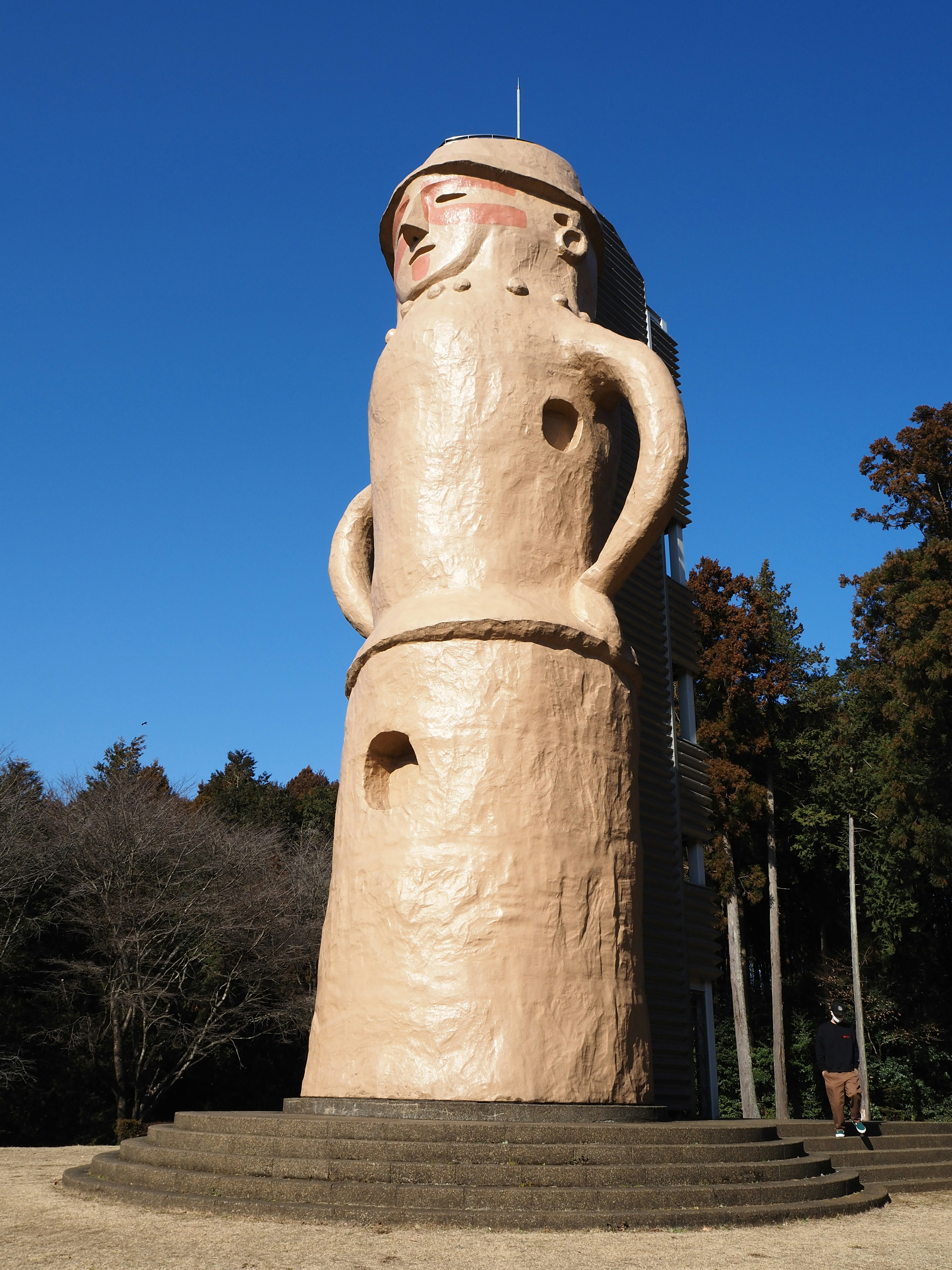 A unique giant sculpture stands under a blue sky