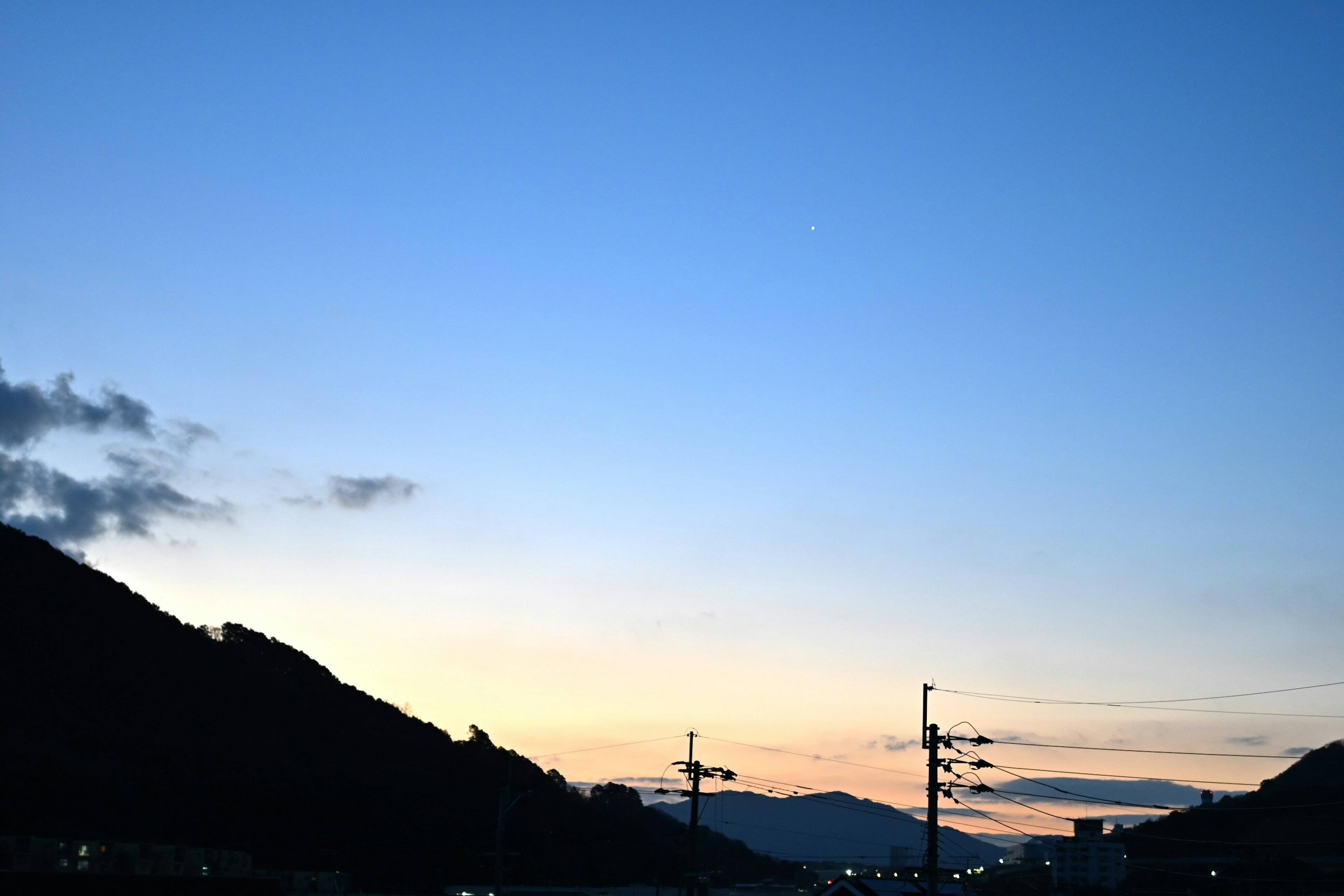 Silhouette of mountains against a twilight sky