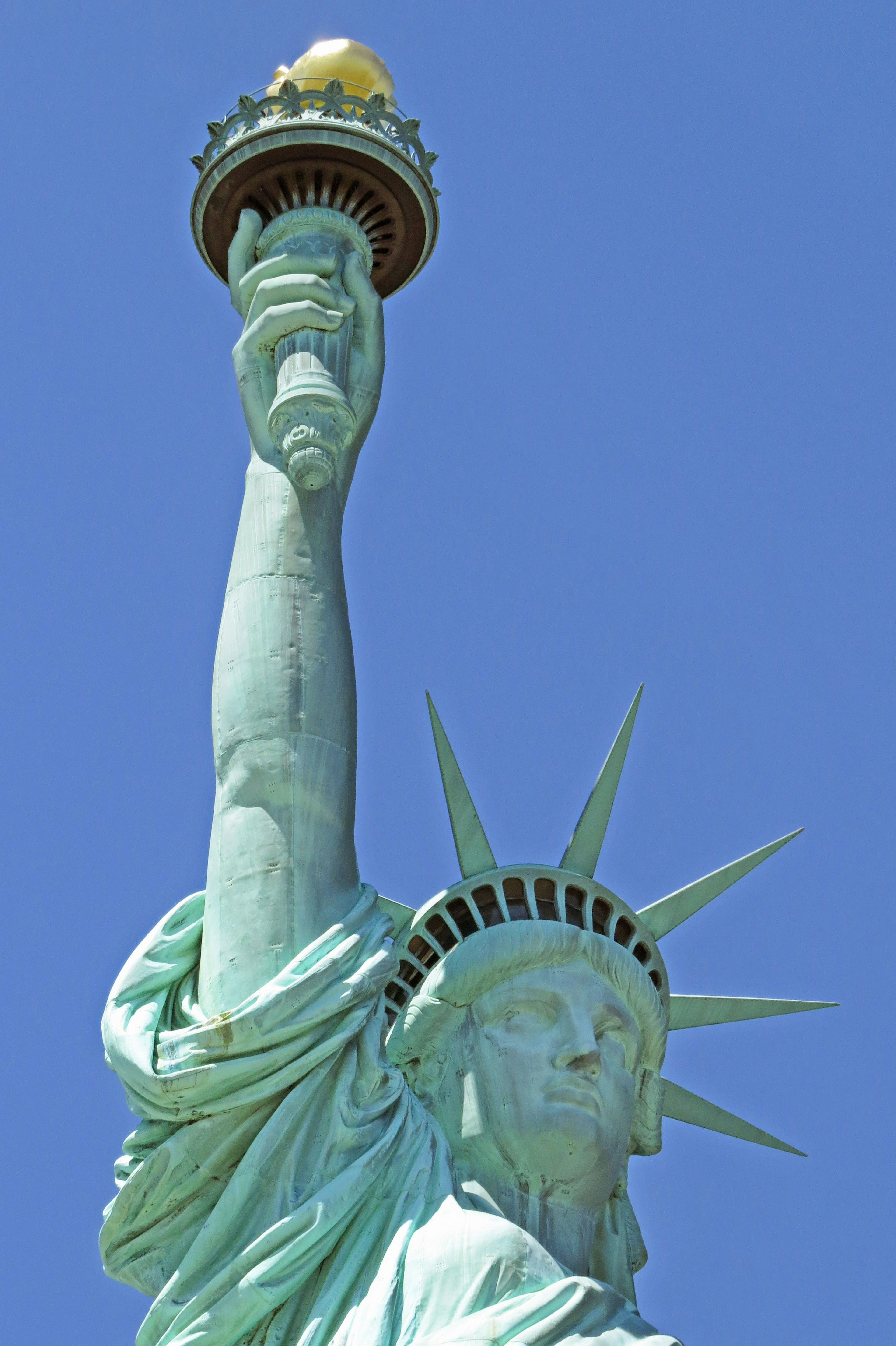 Statue of Liberty's arm raised holding the torch