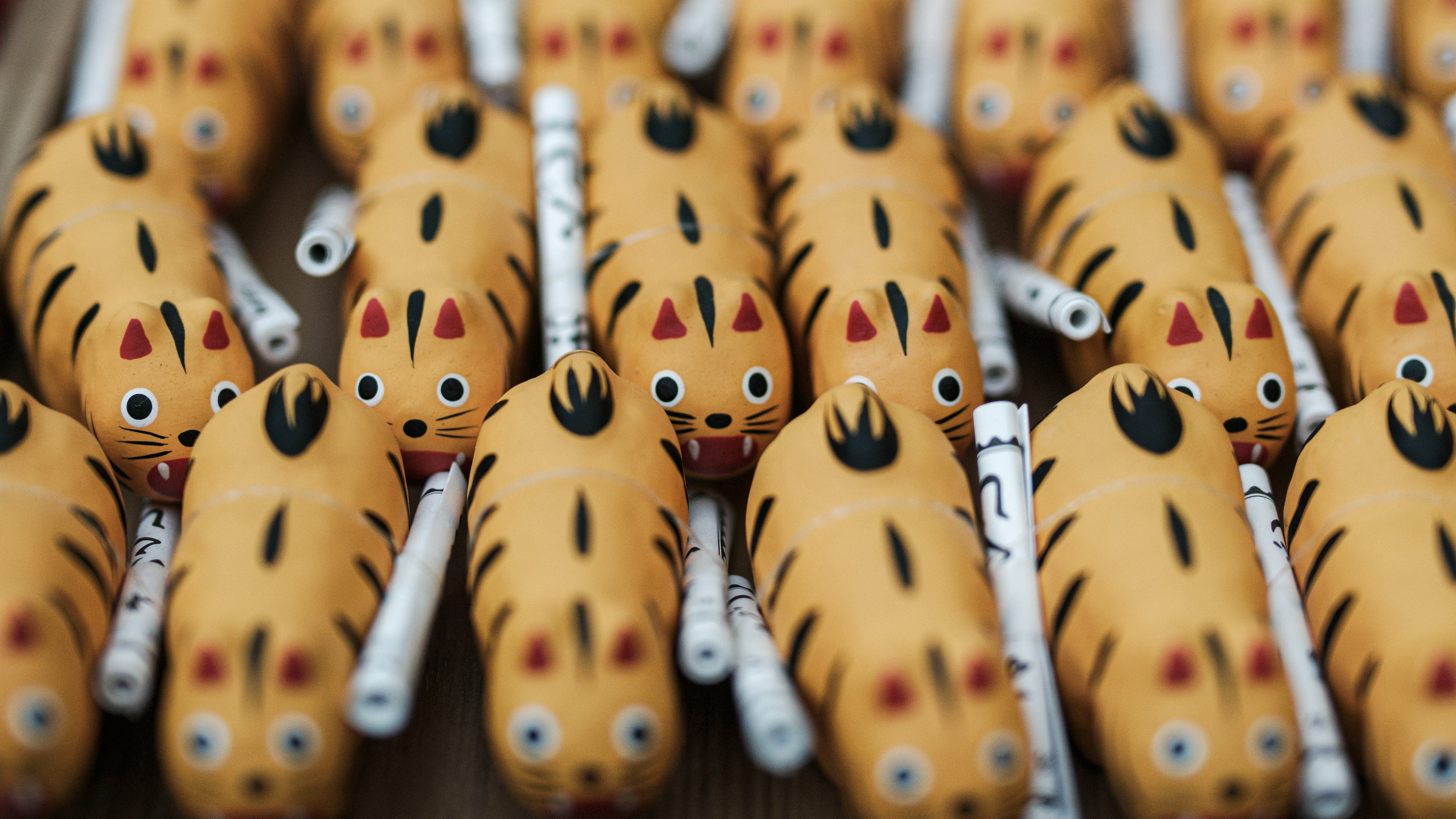 A collection of orange tiger-shaped figures with black stripes