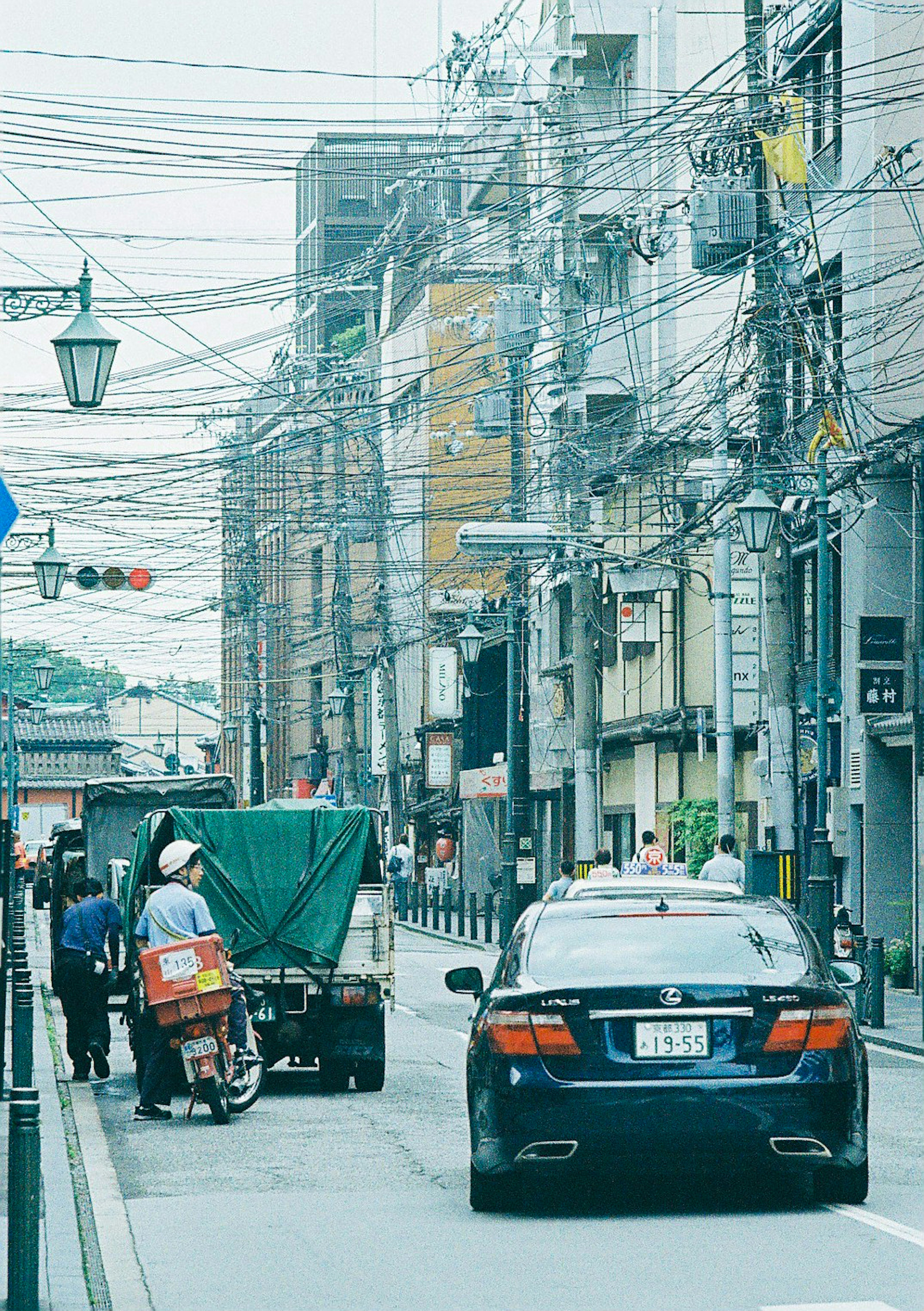 Urban street scene with a car and motorcycle in motion