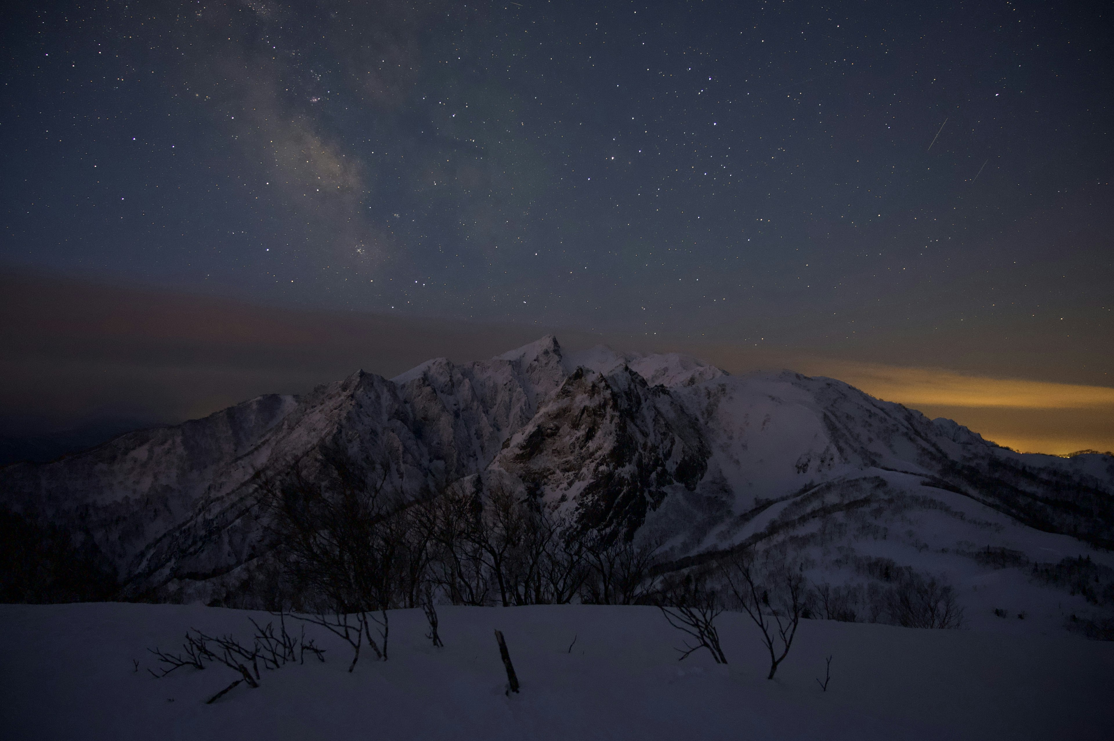 Montagne coperte di neve sotto un cielo stellato